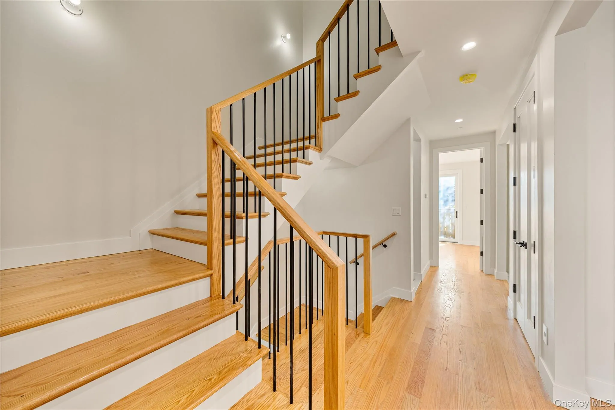 Stairway with wood finished floors and recessed lighting Stairway with wood finished floors and recessed lighting
