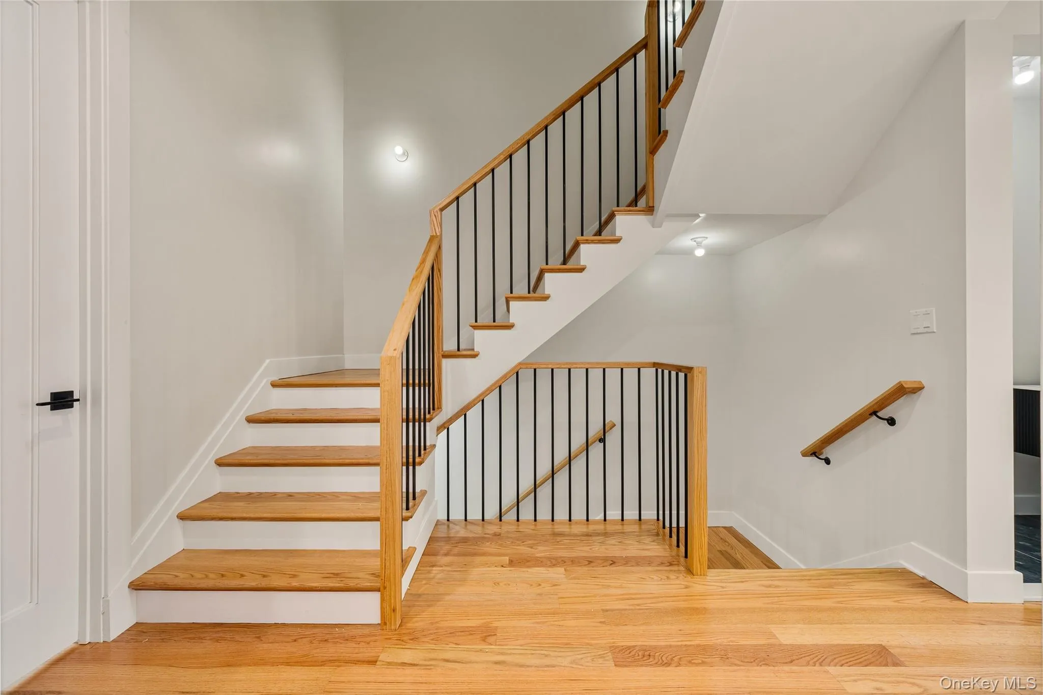 Staircase with wood finished floors and baseboards Staircase with wood finished floors and baseboards