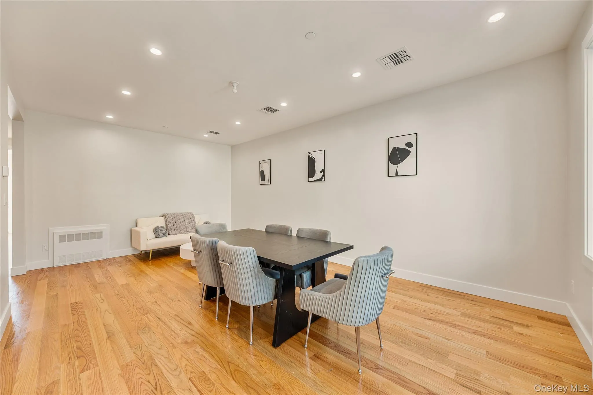 Dining room with recessed lighting and light wood-style floors Dining room with recessed lighting and light wood-style floors