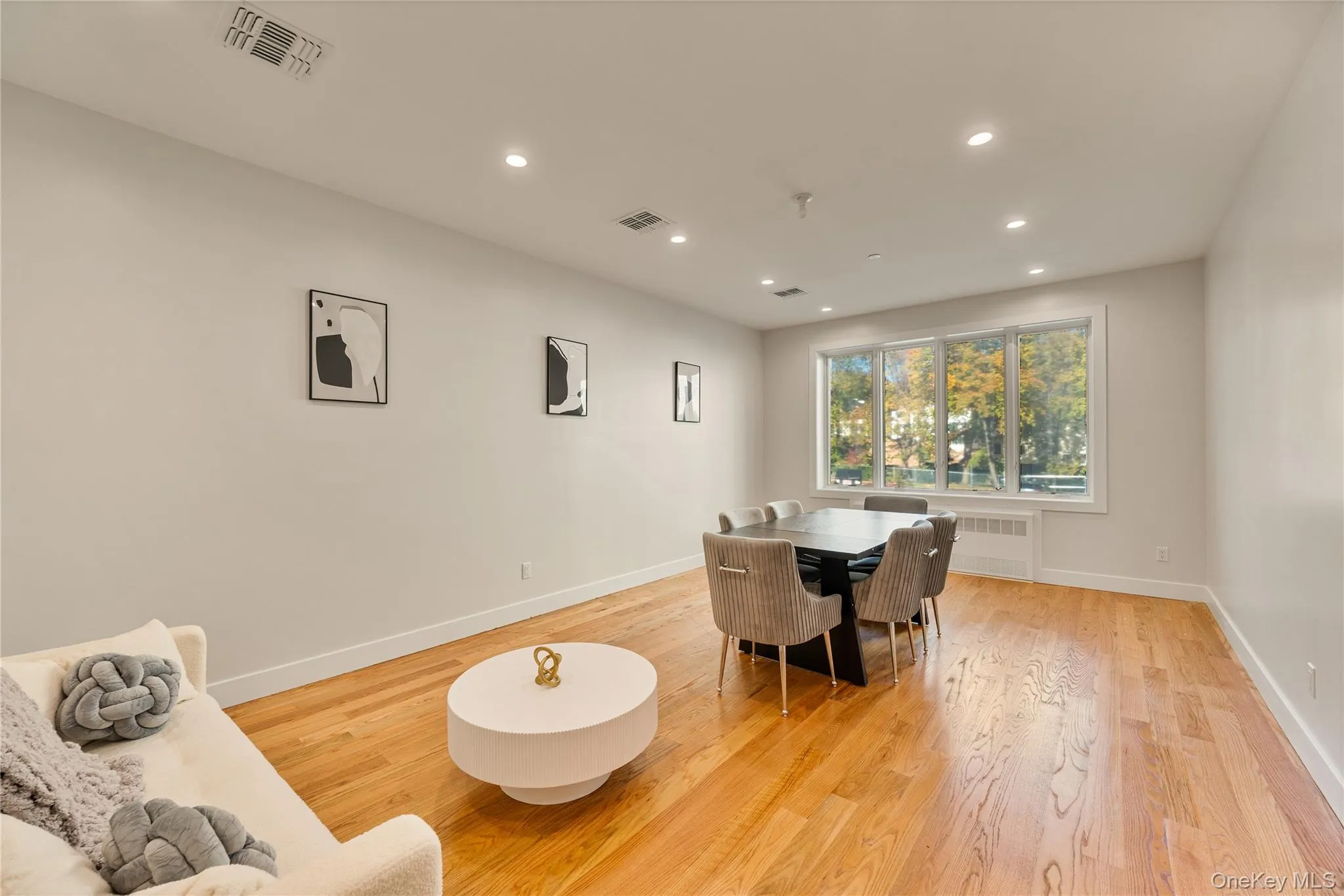 Dining space featuring recessed lighting, light wood-type flooring, and radiator Dining space featuring recessed lighting, light wood-type flooring, and radiator