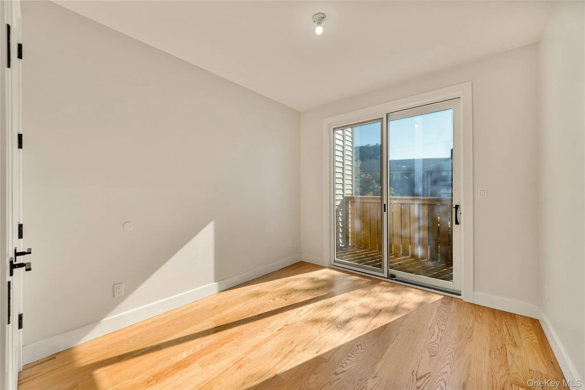 Unfurnished room featuring wood finished floors and baseboards Unfurnished room featuring wood finished floors and baseboards