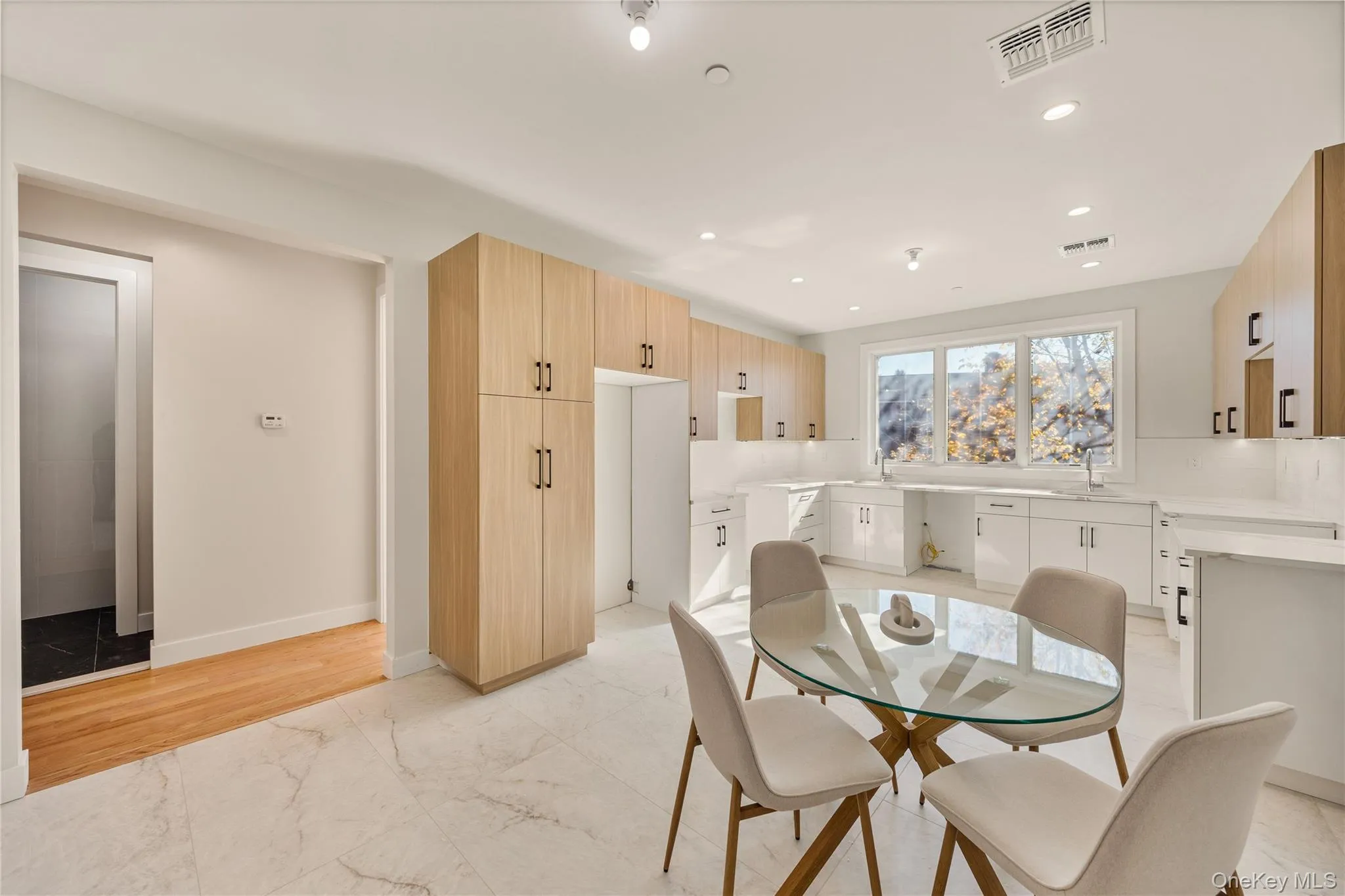 Dining space featuring recessed lighting and light marble finish flooring Dining space featuring recessed lighting and light marble finish flooring