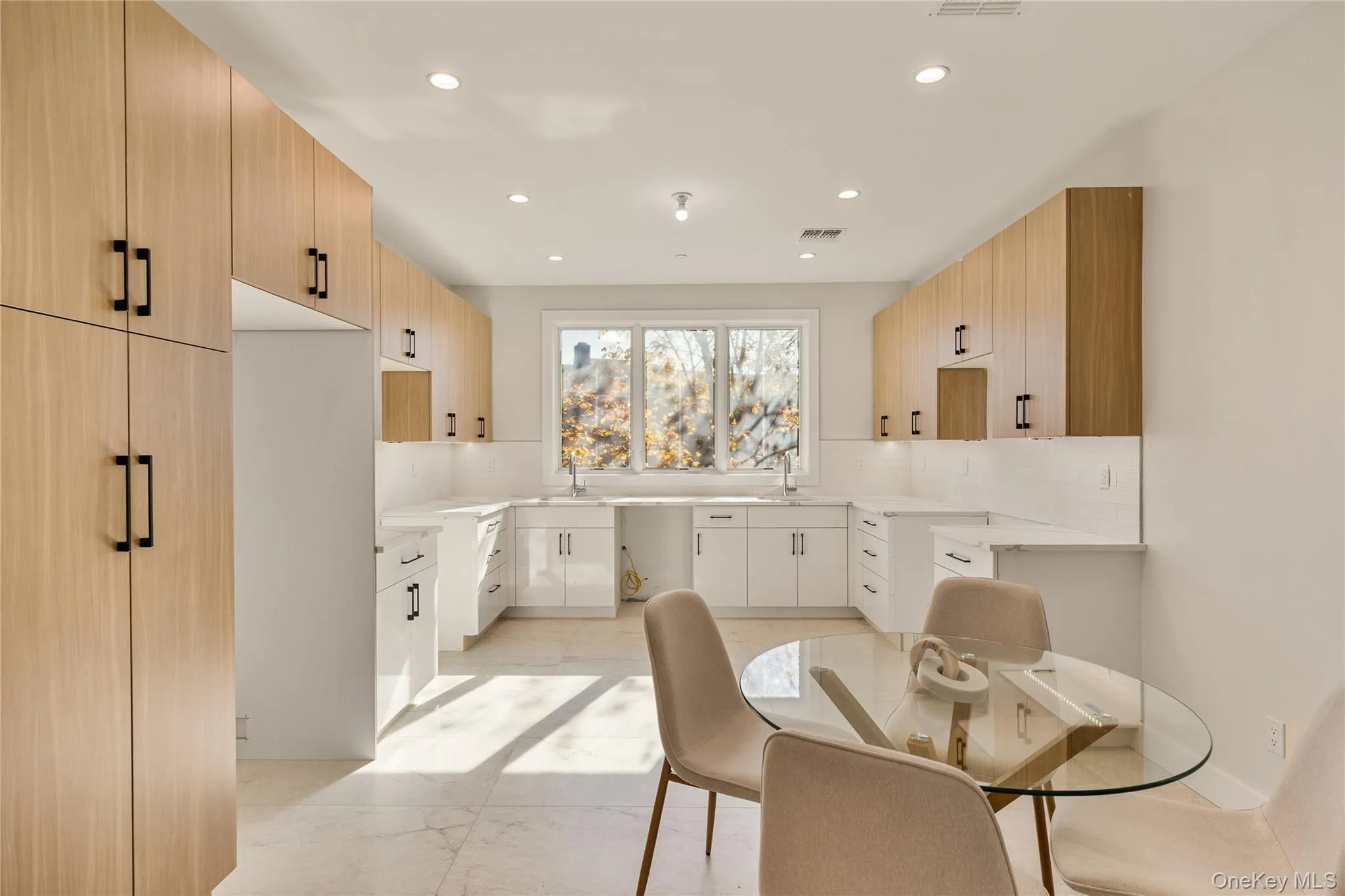 Kitchen featuring light brown cabinets, backsplash, recessed lighting, light stone counters, and modern cabinets Kitchen featuring light brown cabinets, backsplash, recessed lighting, light stone counters, and modern cabinets