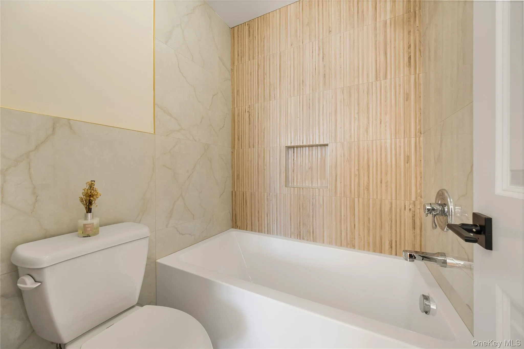 Full bathroom with tile walls and bathing tub / shower combination Full bathroom with tile walls and bathing tub / shower combination