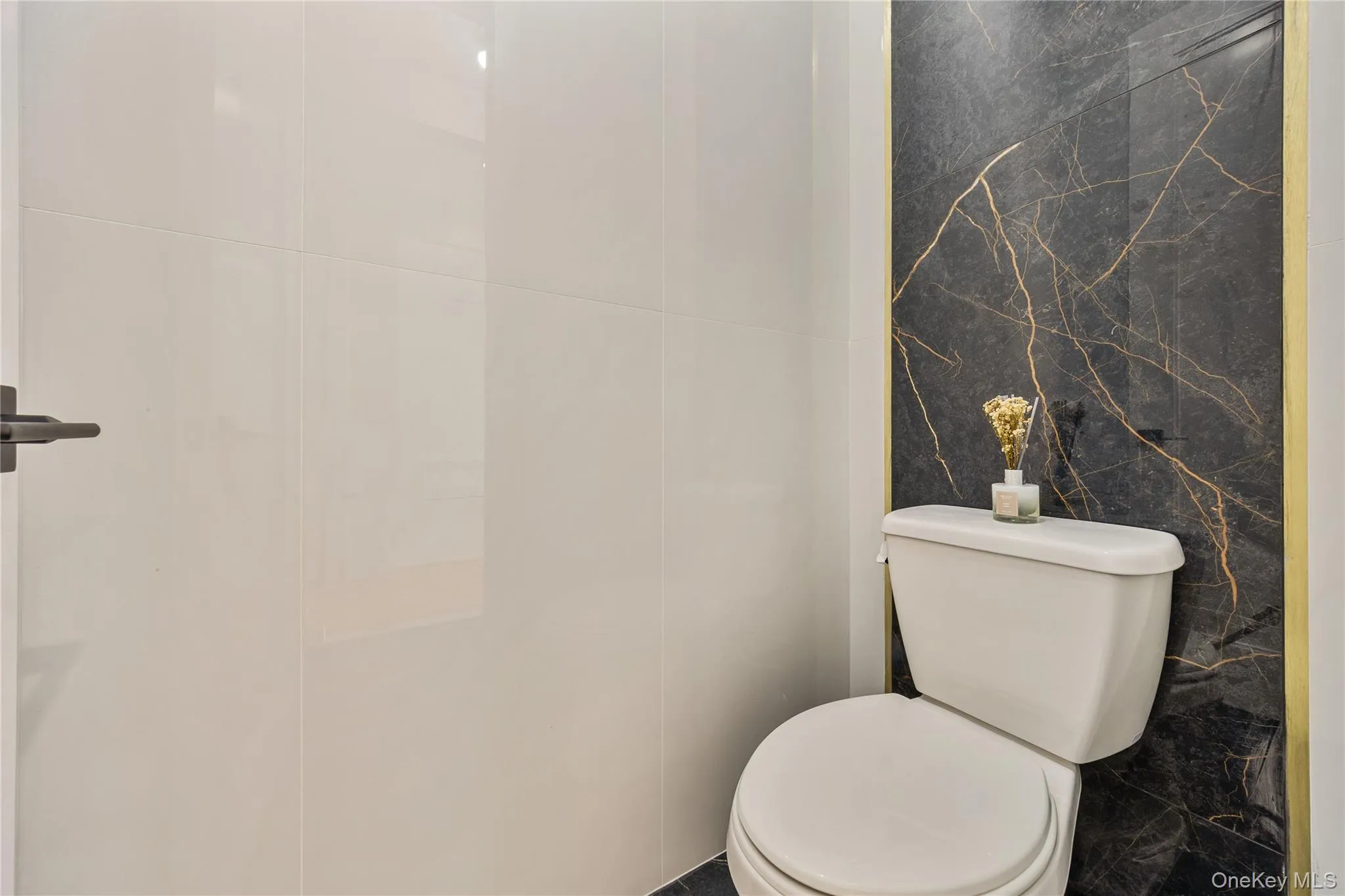 Half bath featuring tile walls and toilet Half bath featuring tile walls and toilet