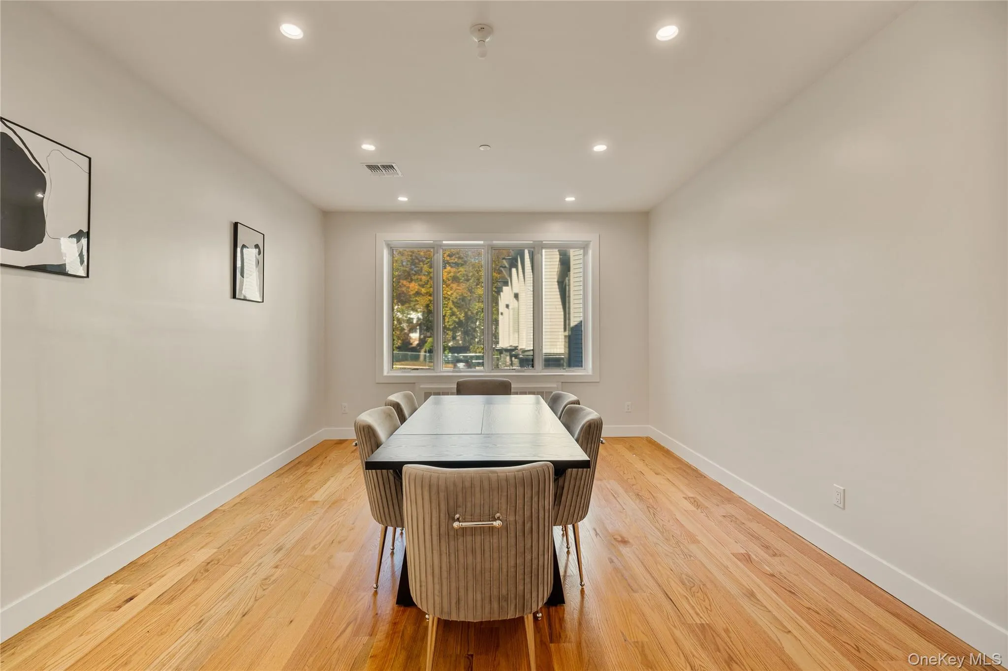 Dining room with recessed lighting and light wood finished floors Dining room with recessed lighting and light wood finished floors
