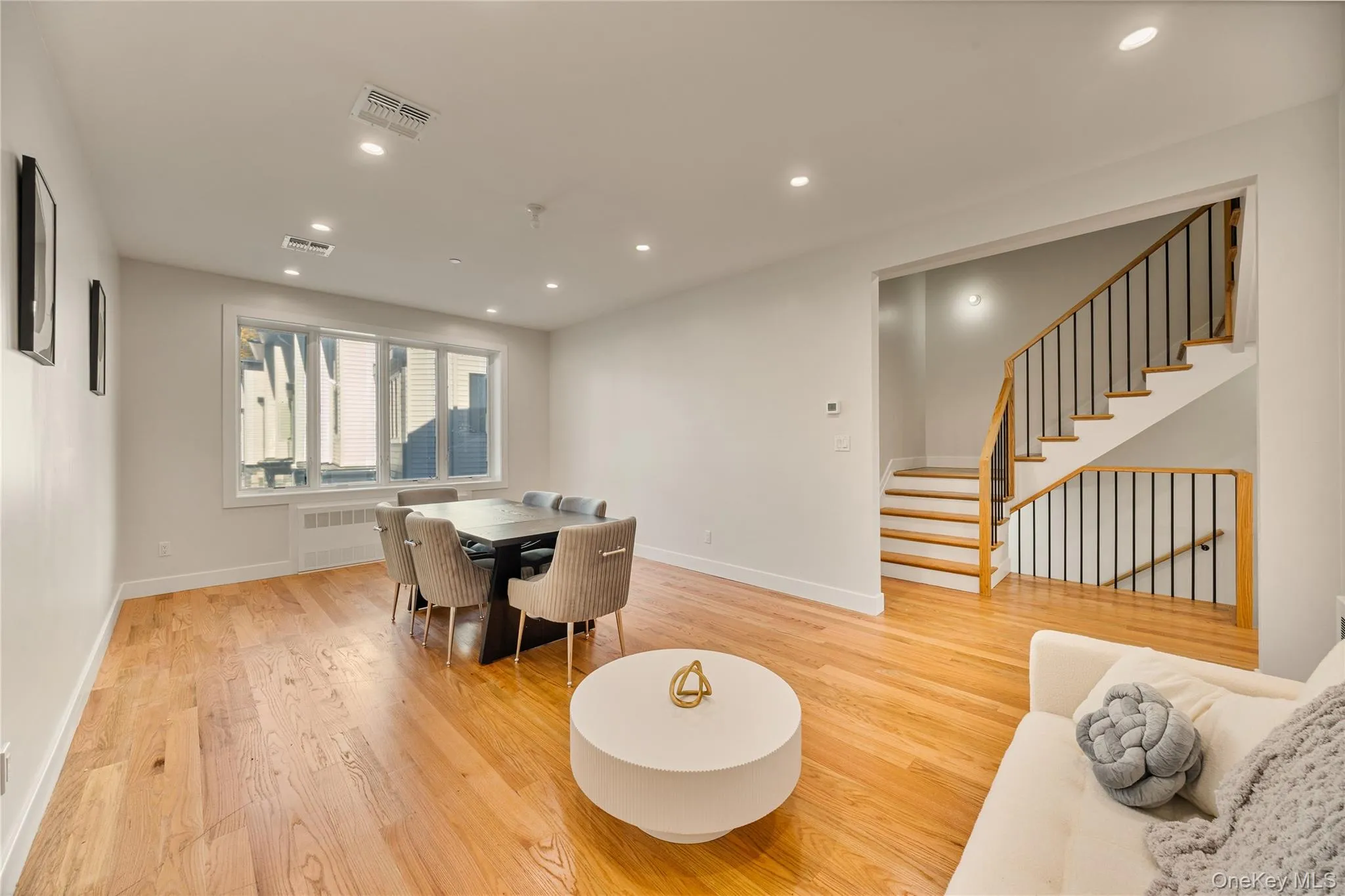 Dining area featuring recessed lighting, light wood finished floors, and stairway Dining area featuring recessed lighting, light wood finished floors, and stairway