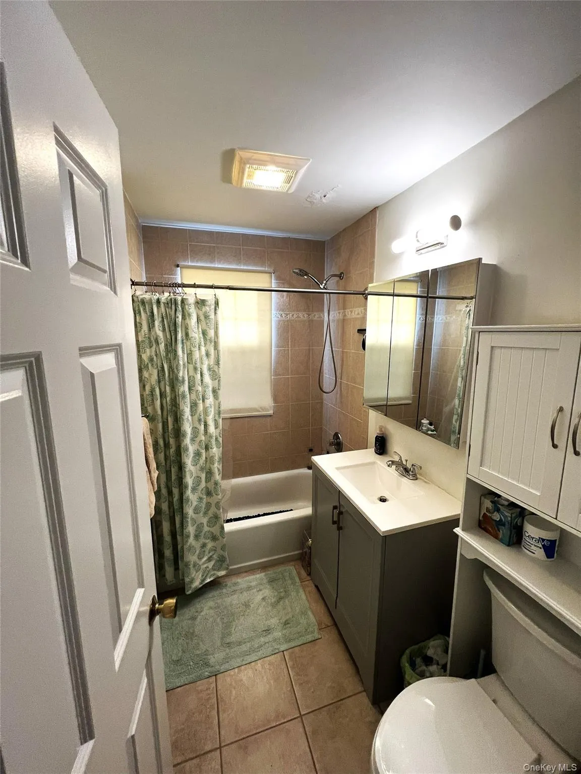 Full bathroom with shower / tub combo, vanity, and light tile patterned flooring Full bathroom with shower / tub combo, vanity, and light tile patterned flooring