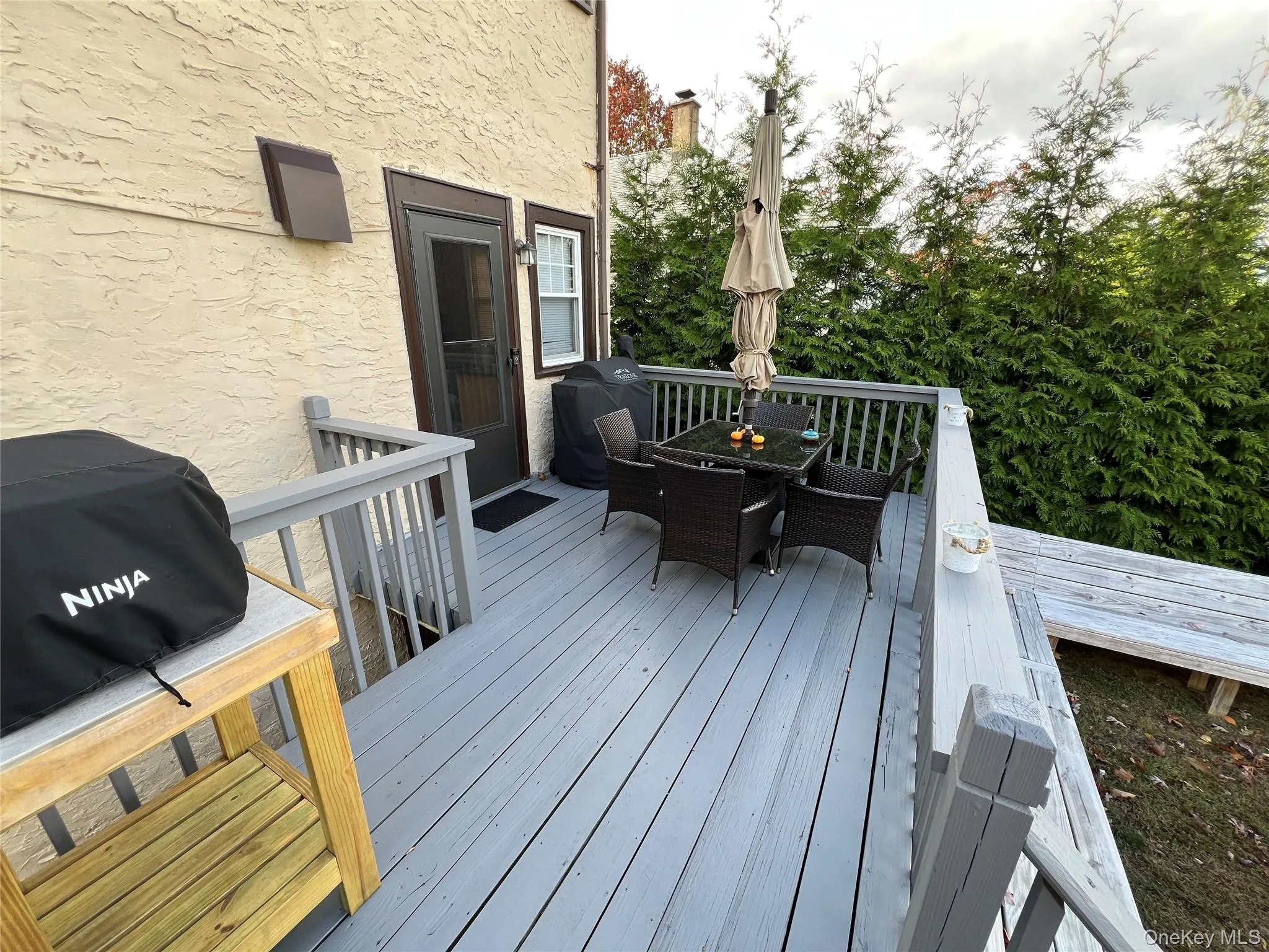 Deck featuring outdoor dining space and area for grilling Deck featuring outdoor dining space and area for grilling