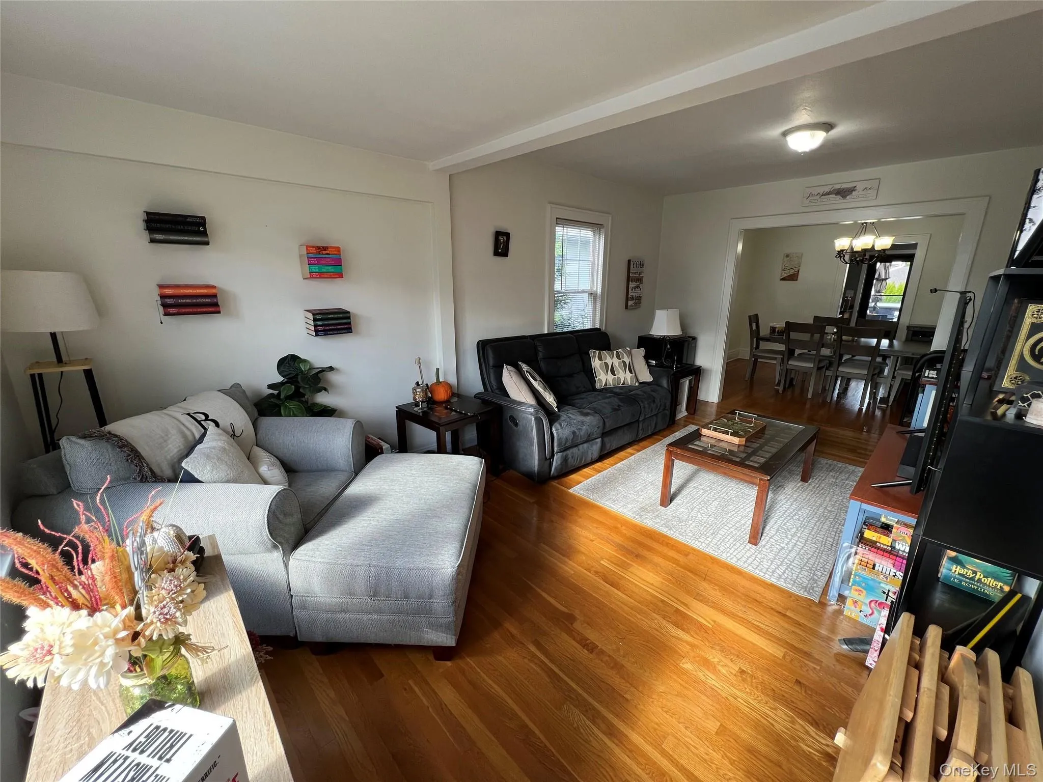 Living room with wood finished floors and a chandelier Living room with wood finished floors and a chandelier