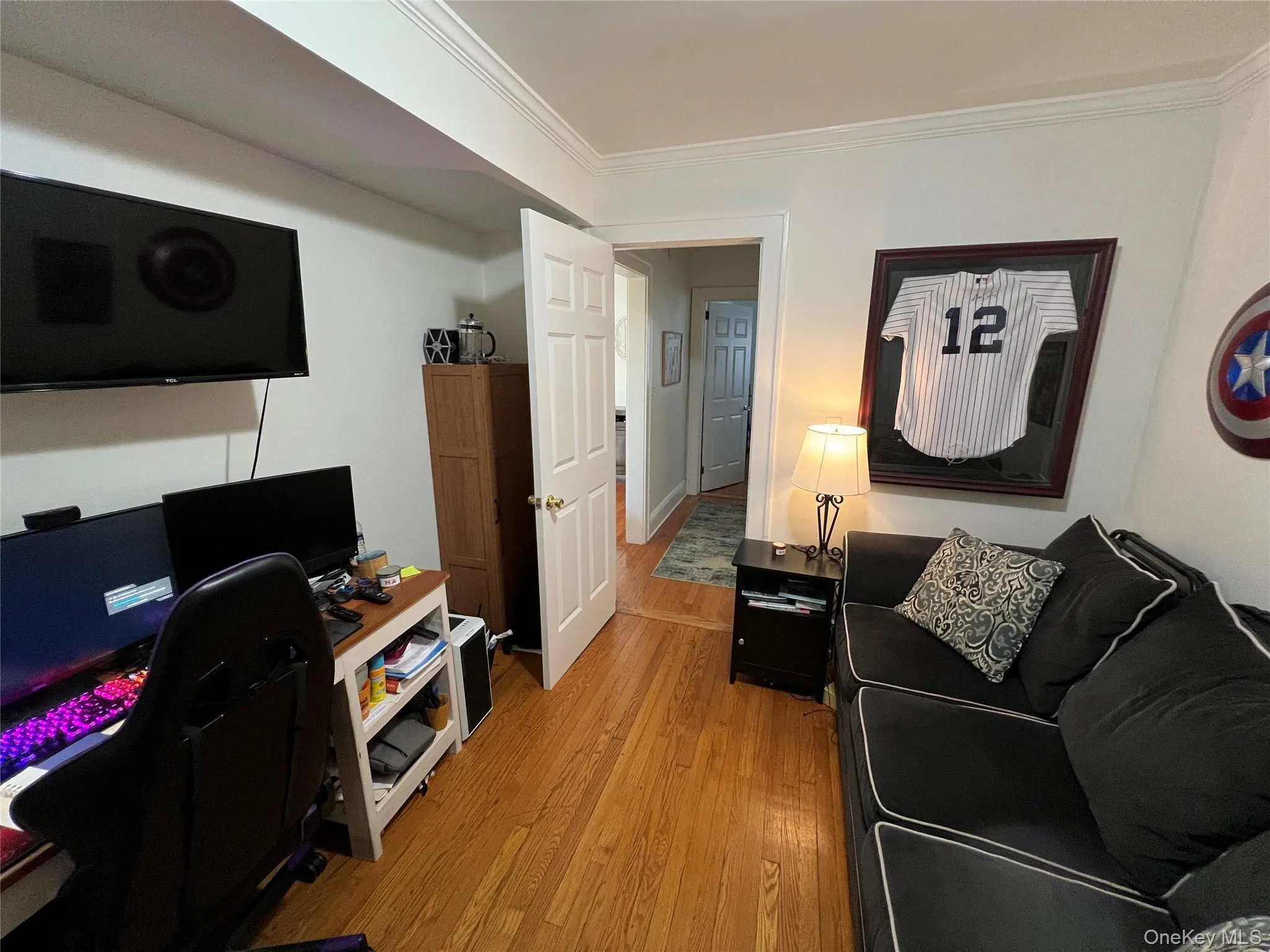 Home office with light wood finished floors and ornamental molding Home office with light wood finished floors and ornamental molding