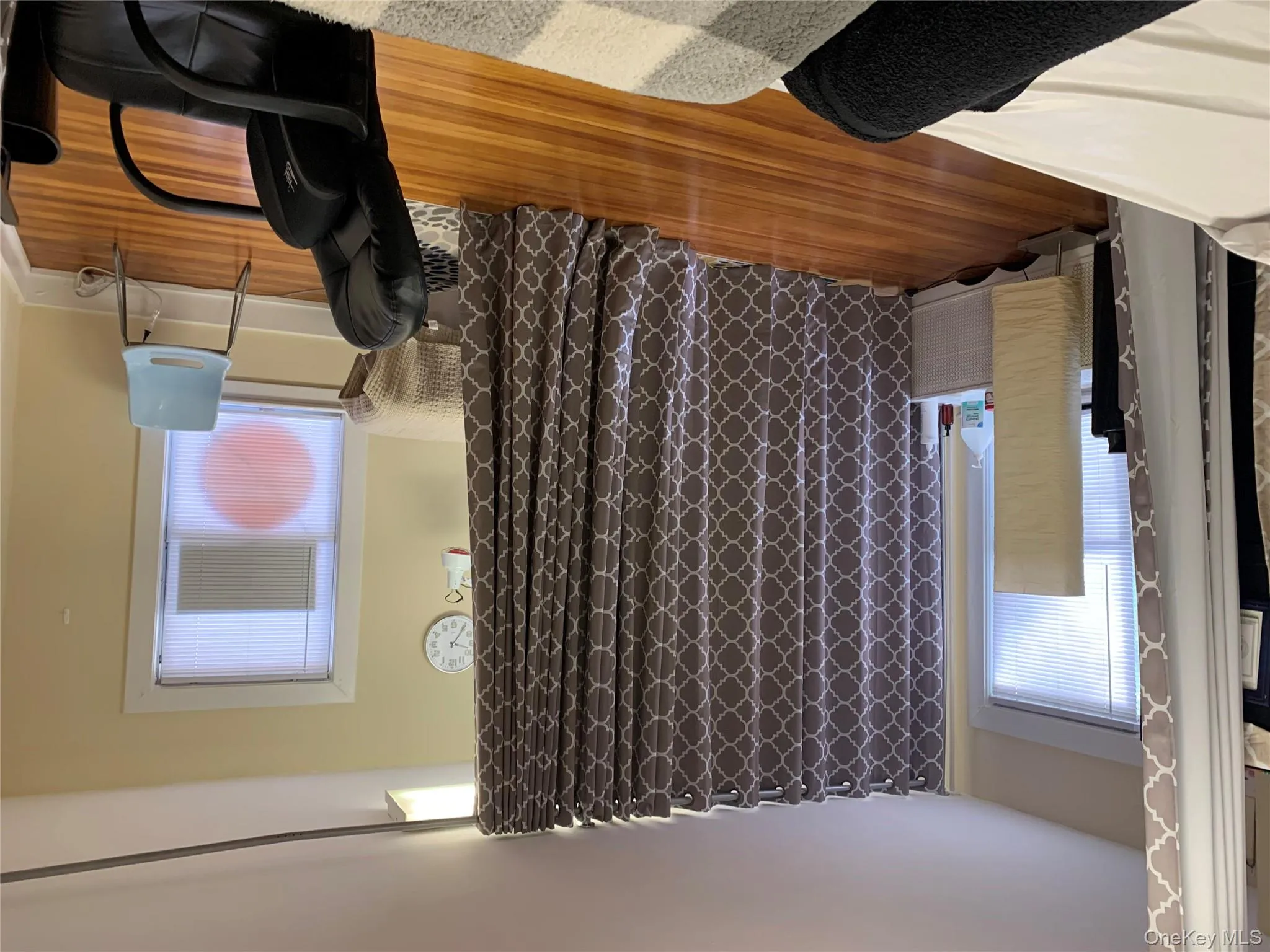 Bedroom featuring multiple windows and wood finished floors Bedroom featuring multiple windows and wood finished floors