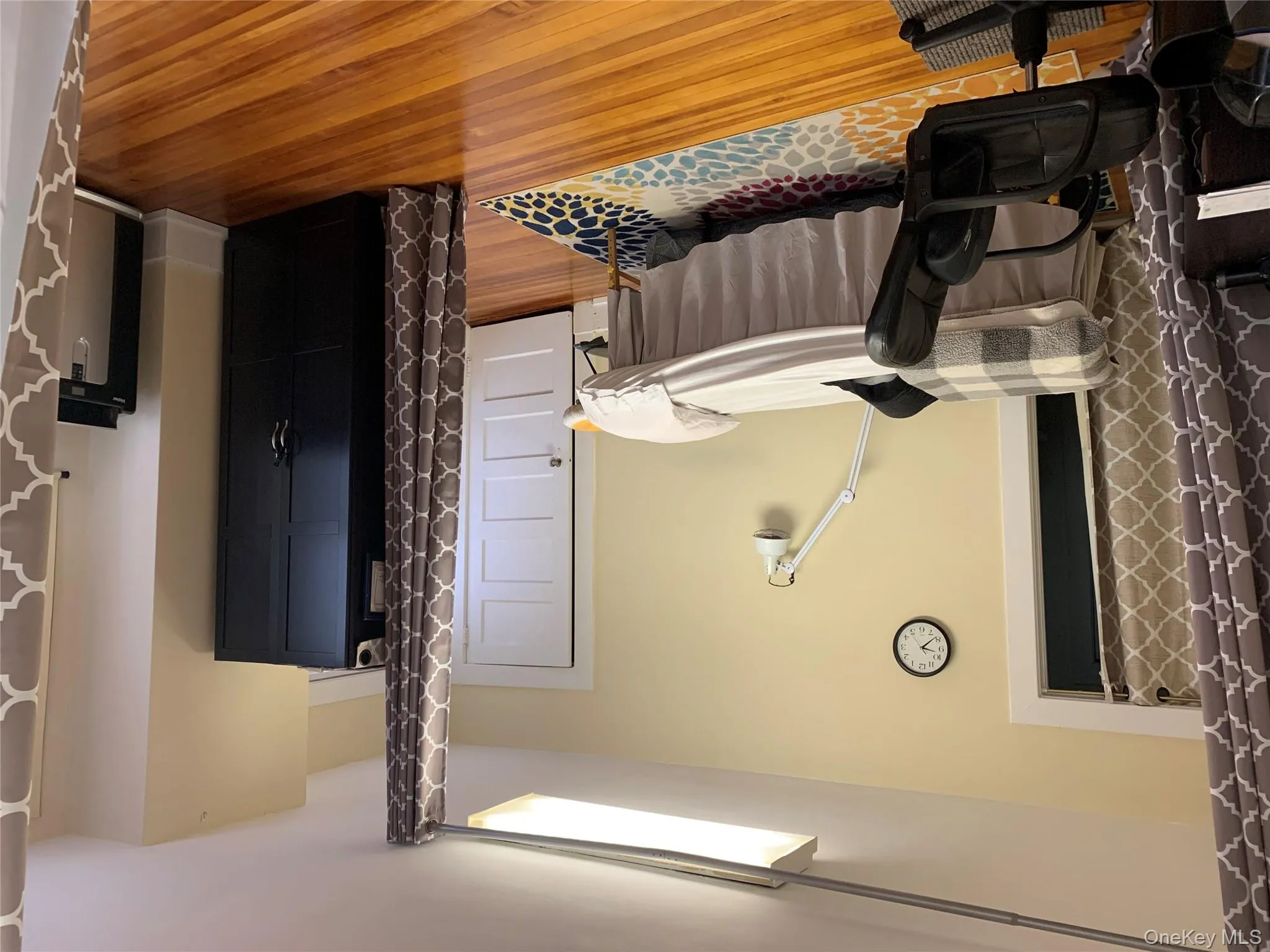 Bedroom with light wood-style flooring and fridge Bedroom with light wood-style flooring and fridge