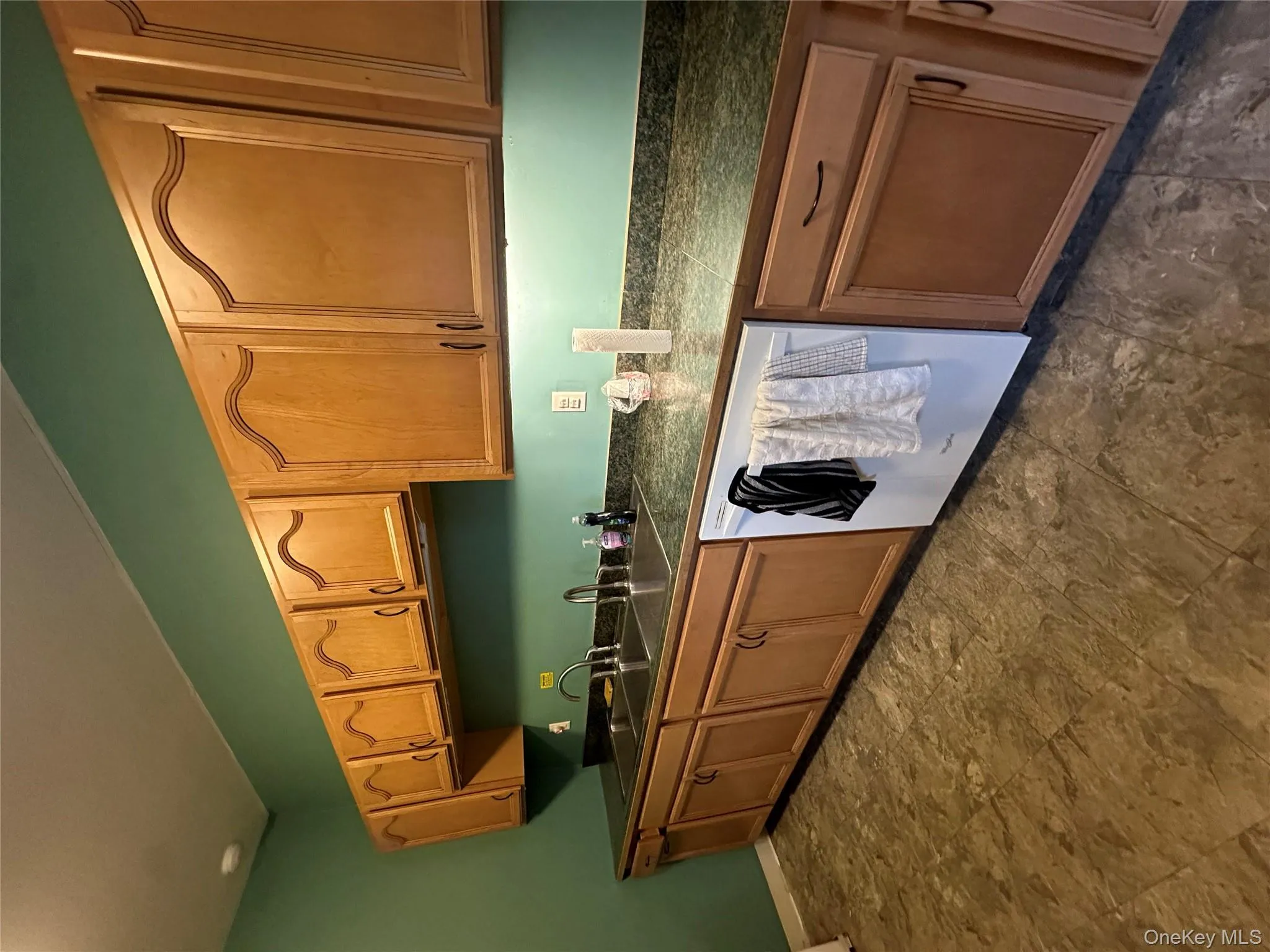Kitchen with dishwasher and brown cabinetry Kitchen with dishwasher and brown cabinetry
