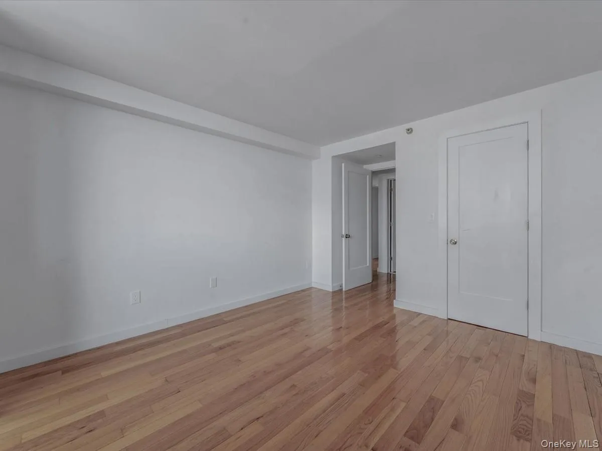 Unfurnished bedroom with light wood-style floors and baseboards Unfurnished bedroom with light wood-style floors and baseboards