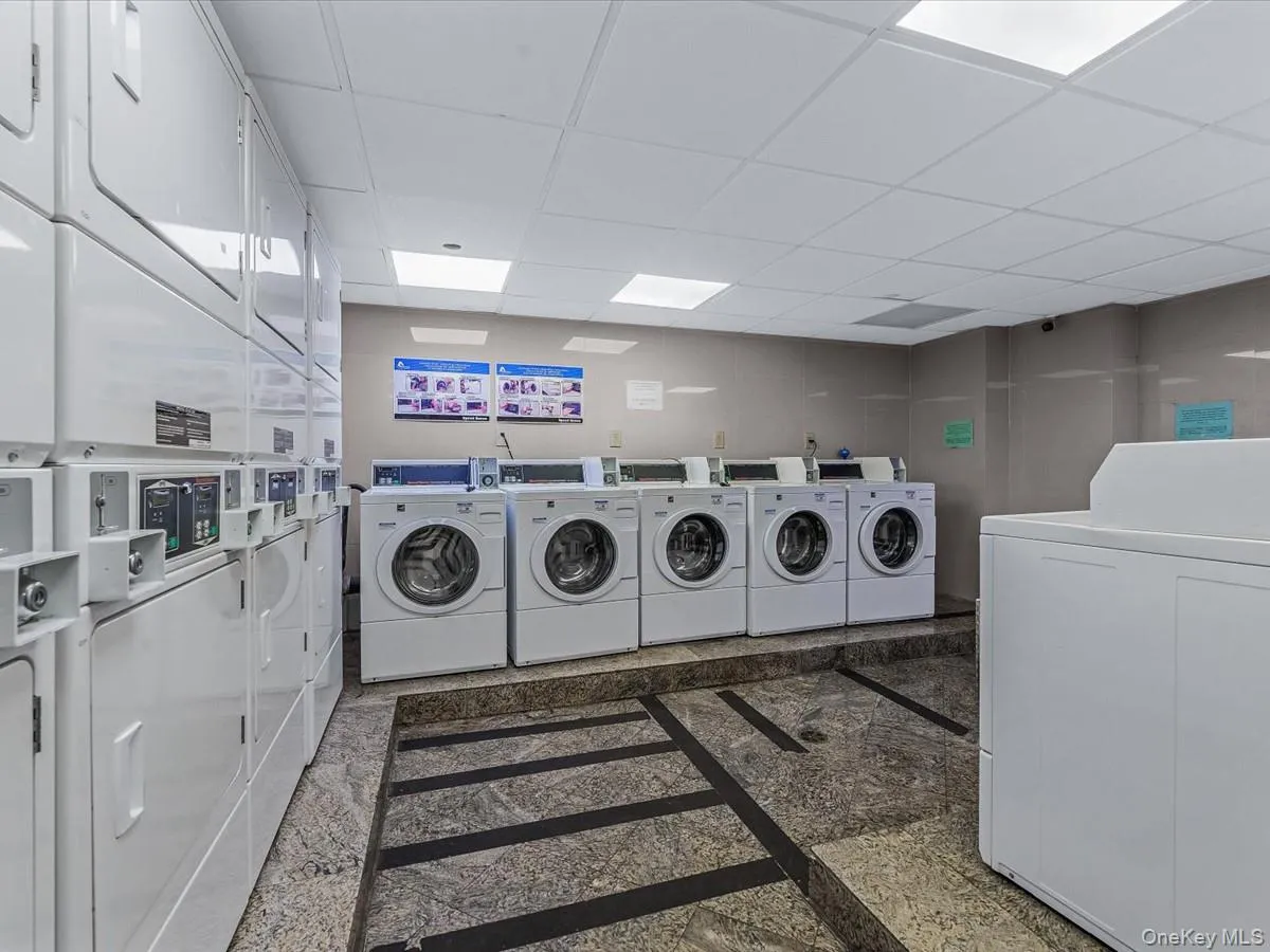 Community laundry with a drop ceiling and washing machine and dryer Community laundry with a drop ceiling and washing machine and dryer