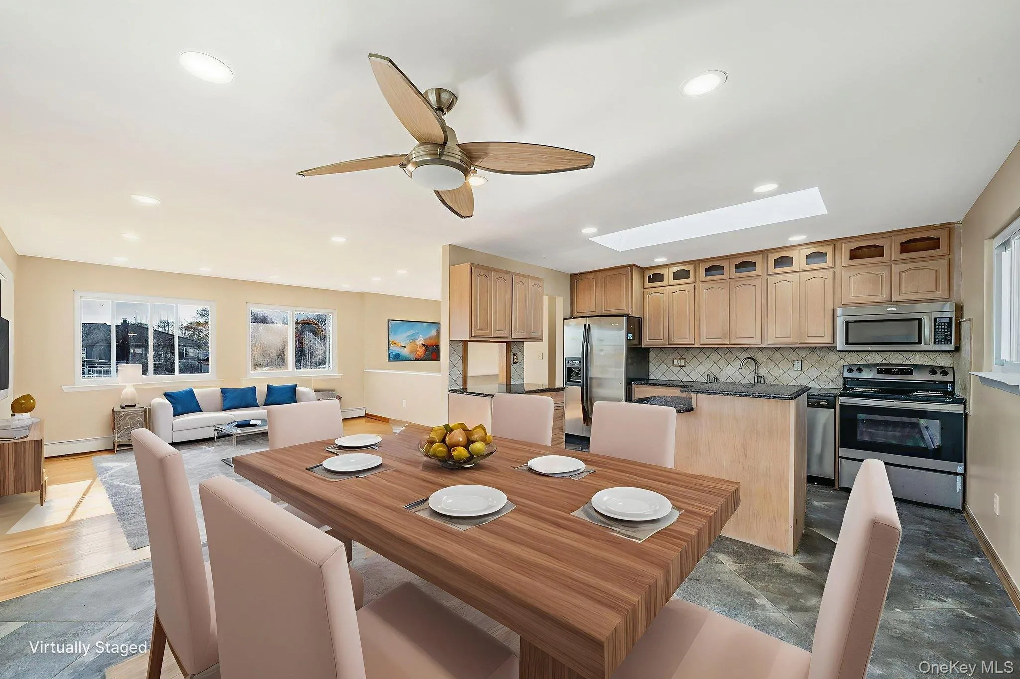 Dining room with plenty of natural light, a skylight, a ceiling fan, and recessed lighting Dining room with plenty of natural light, a skylight, a ceiling fan, and recessed lighting