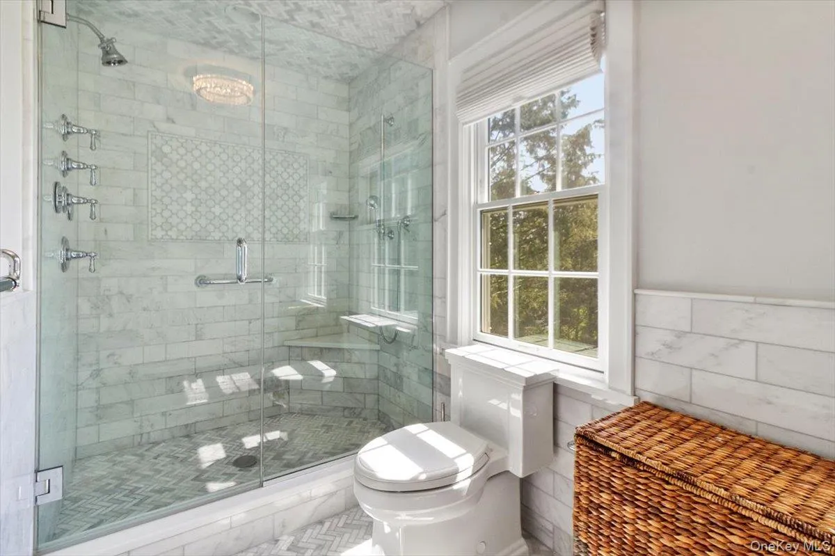 Bathroom with a stall shower and tile walls Bathroom with a stall shower and tile walls