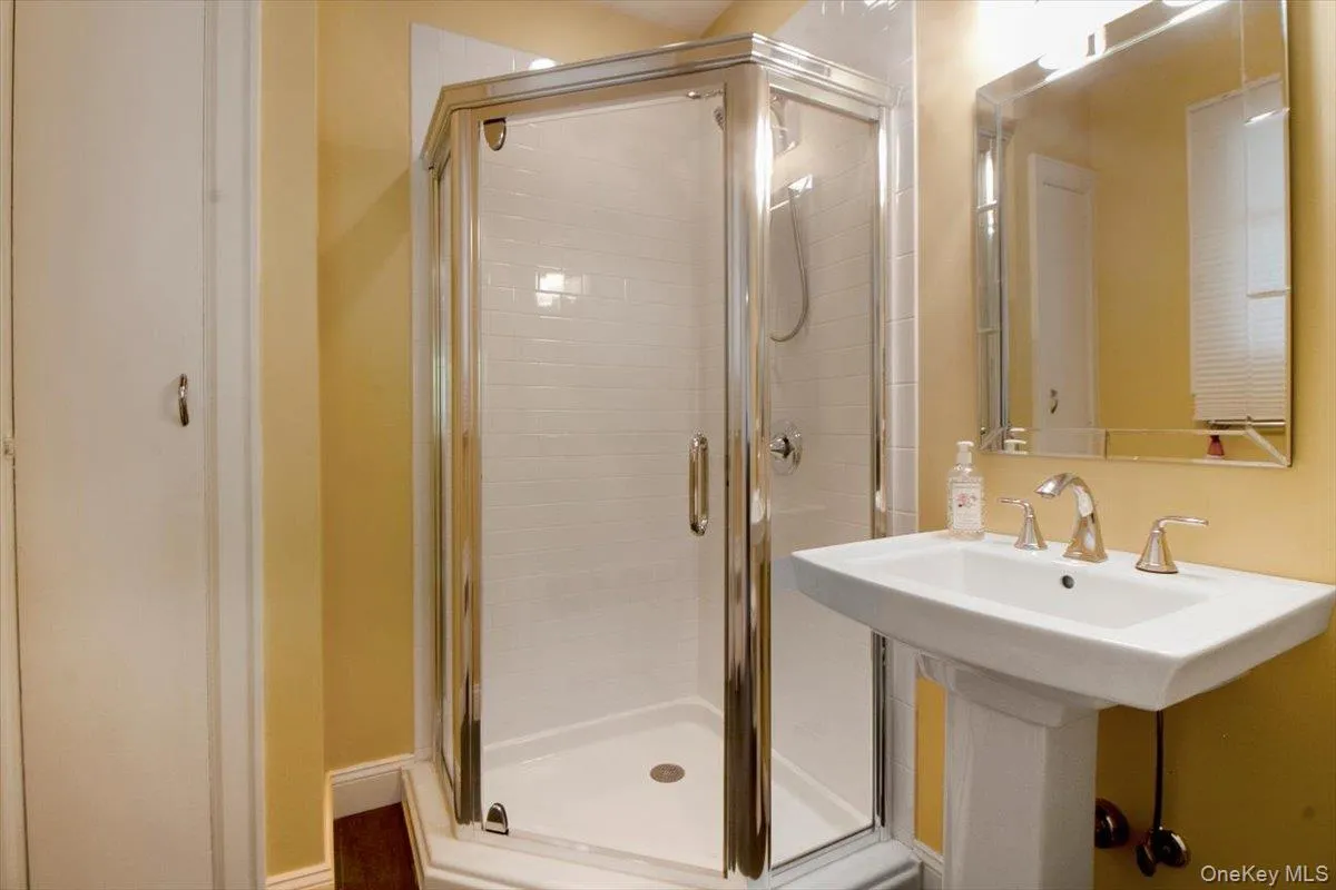 Bathroom with a stall shower and a sink Bathroom with a stall shower and a sink