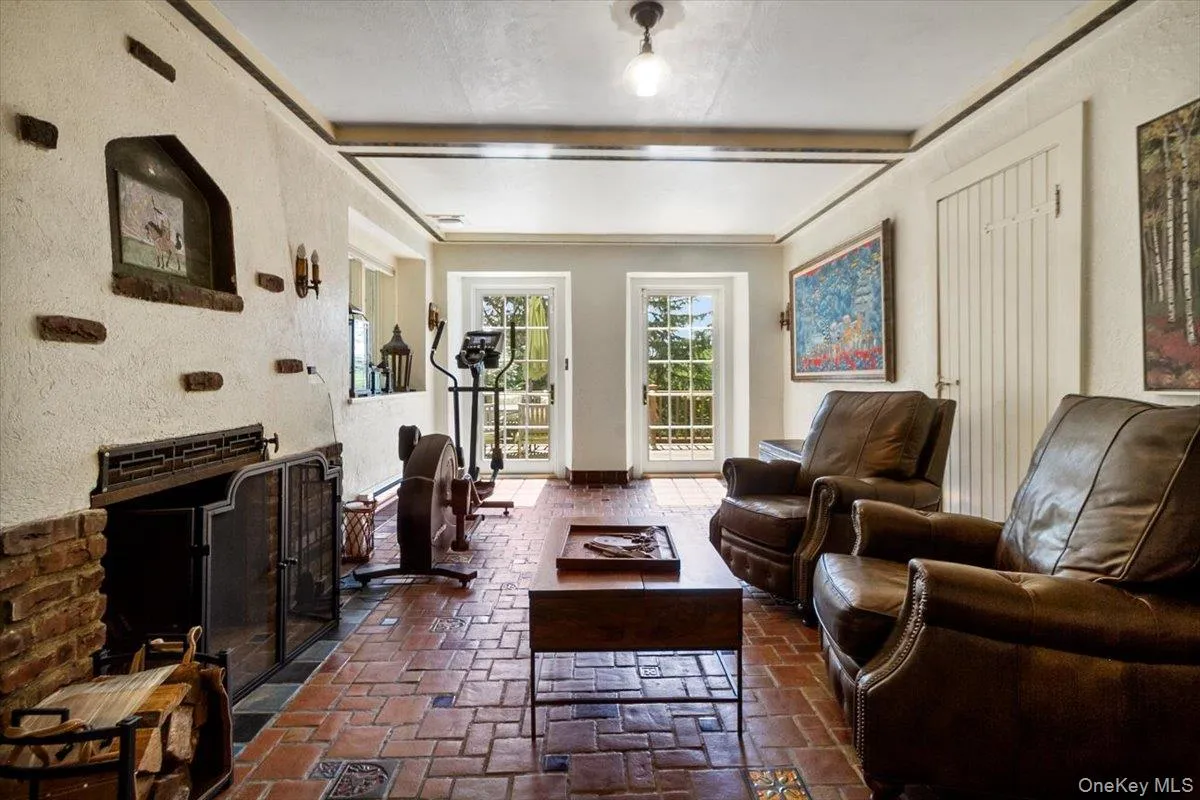Living area with beamed ceiling and a textured wall Living area with beamed ceiling and a textured wall