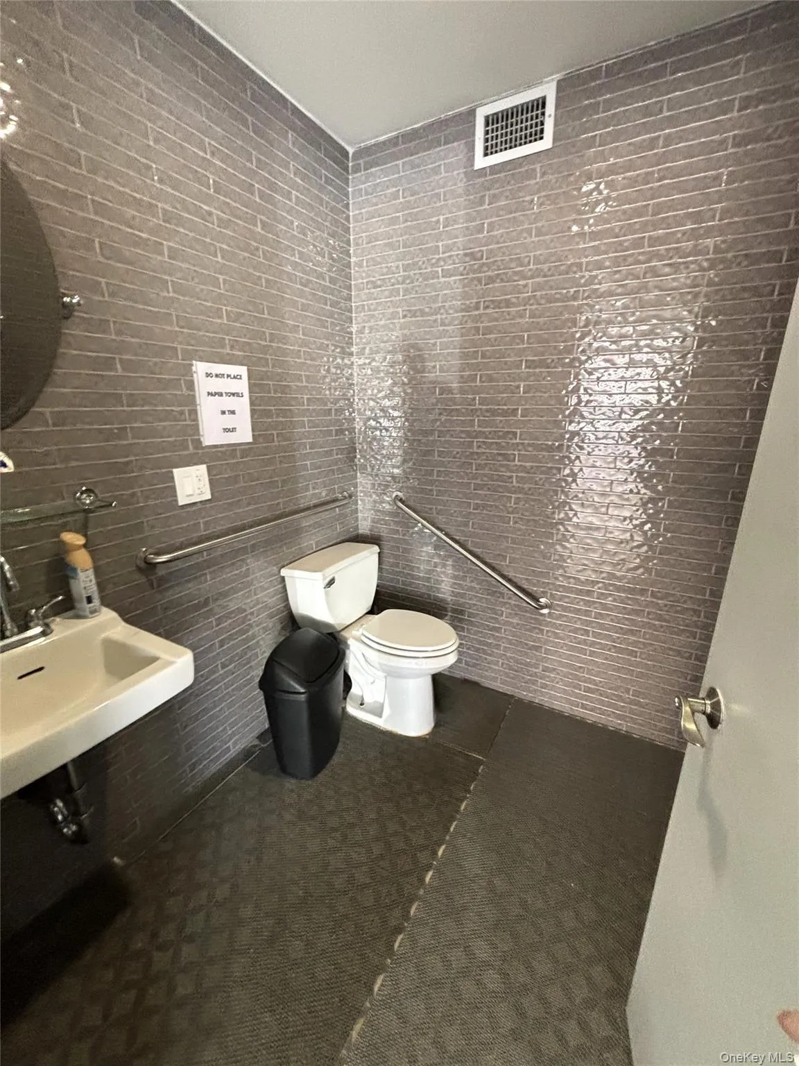 Half bathroom with tile walls and toilet Half bathroom with tile walls and toilet