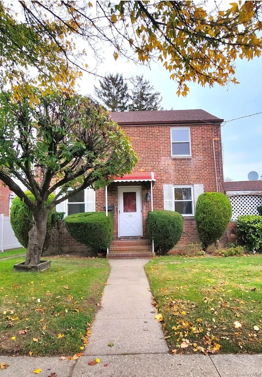 View of front facade featuring brick siding and a front lawn View of front facade featuring brick siding and a front lawn