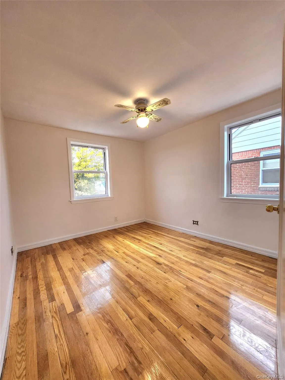 Empty room with light wood-type flooring and ceiling fan Empty room with light wood-type flooring and ceiling fan