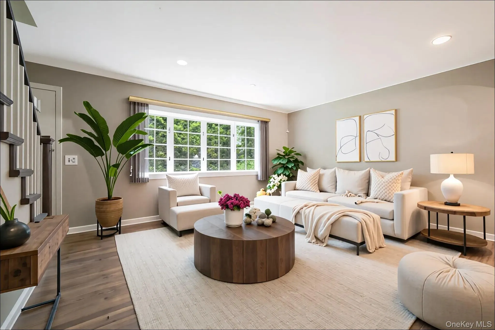 Living room featuring wood finished floors, recessed lighting, and stairs Living room featuring wood finished floors, recessed lighting, and stairs