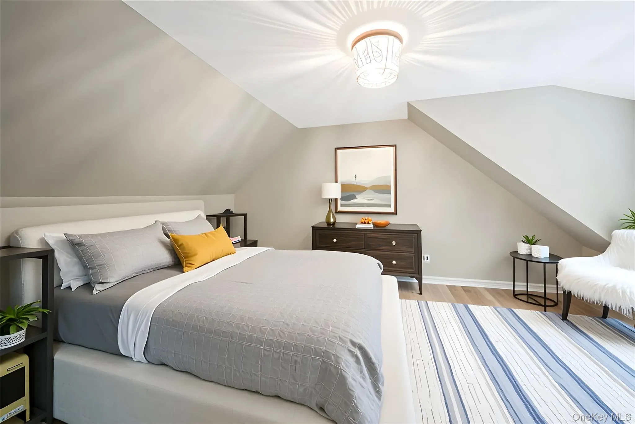 Bedroom with lofted ceiling and light wood finished floors Bedroom with lofted ceiling and light wood finished floors