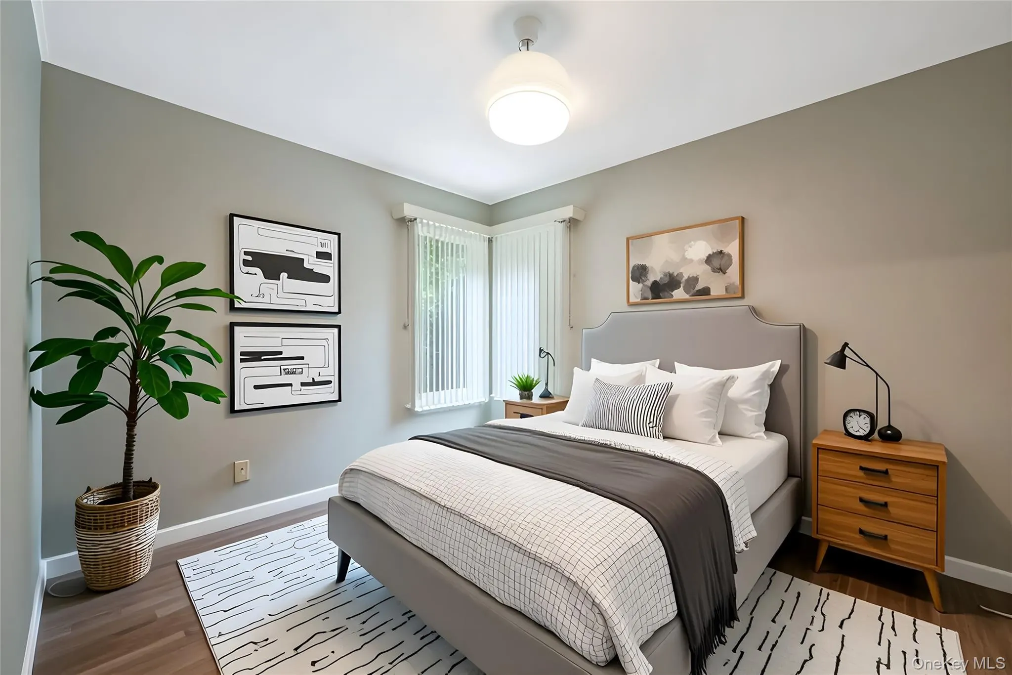 Bedroom with baseboards and wood finished floors Bedroom with baseboards and wood finished floors