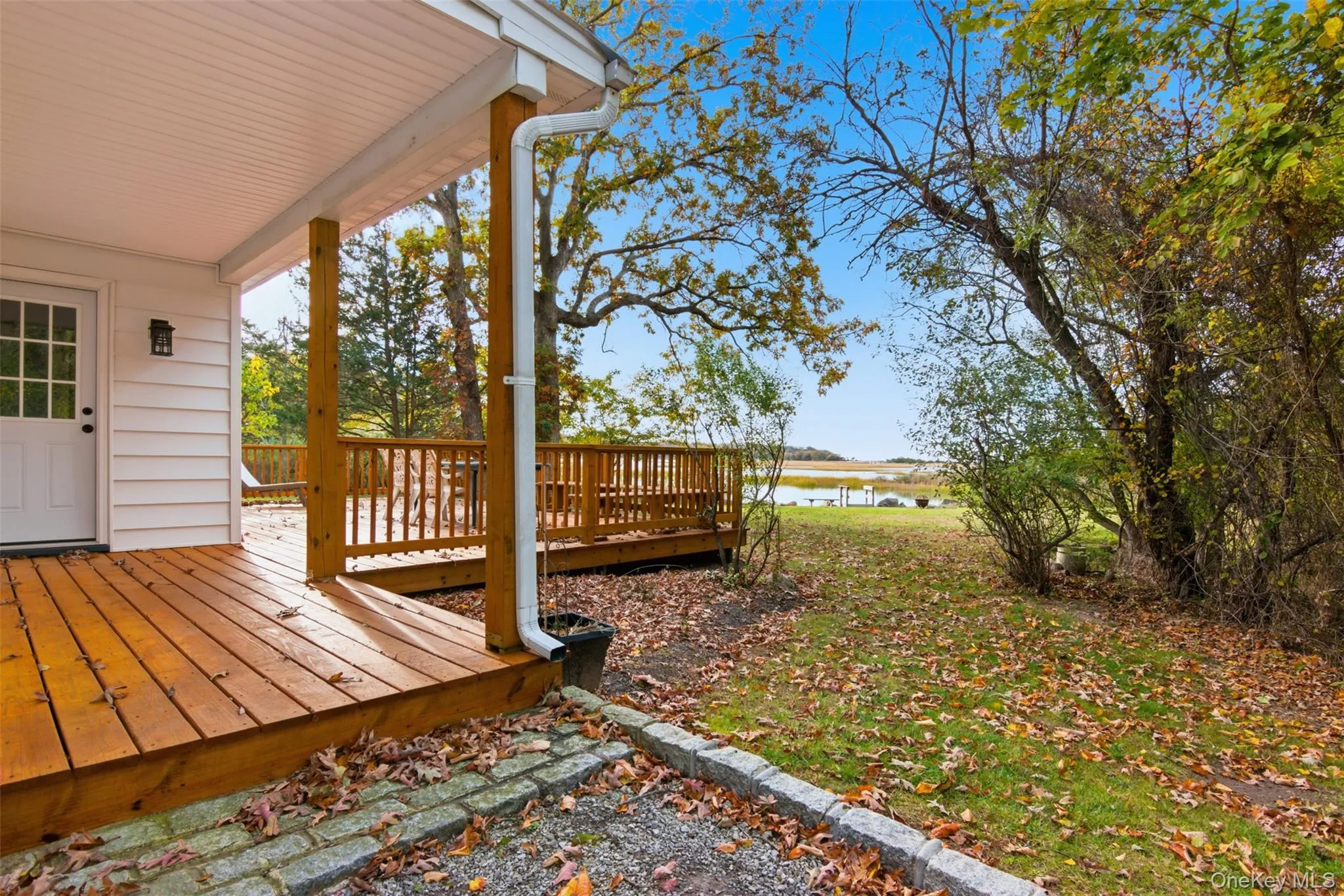 Wooden terrace featuring a water view Wooden terrace featuring a water view