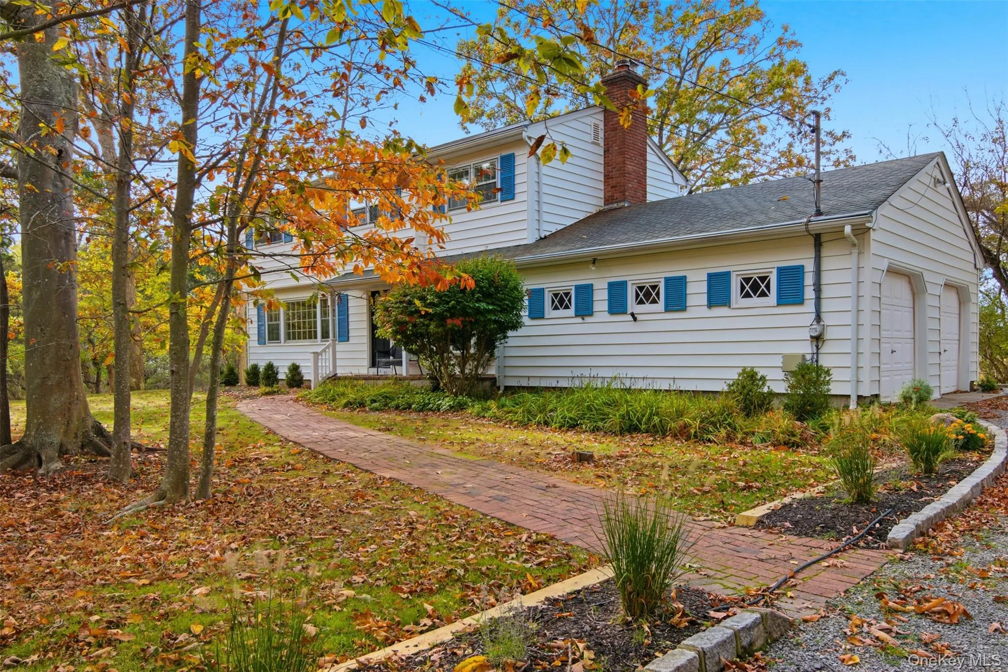 View of property exterior with a garage, a chimney, and roof with shingles View of property exterior with a garage, a chimney, and roof with shingles