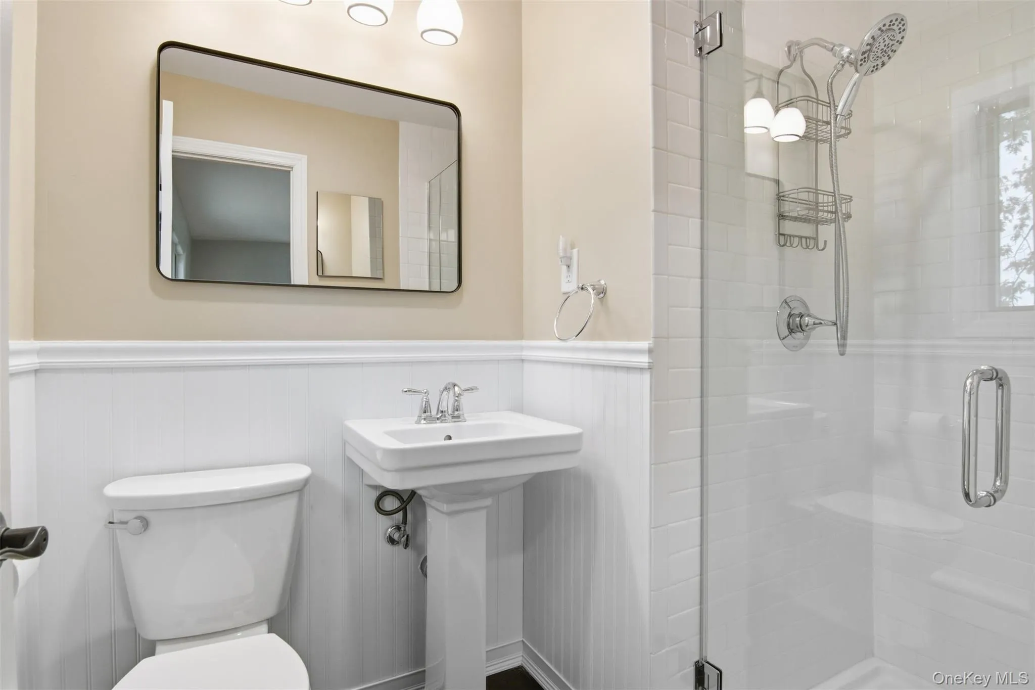 Bathroom with a stall shower and wainscoting Bathroom with a stall shower and wainscoting