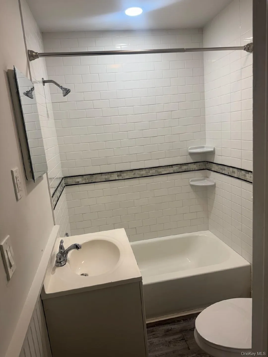 Full bath with vanity, shower / bathtub combination, and dark wood-type flooring Full bath with vanity, shower / bathtub combination, and dark wood-type flooring
