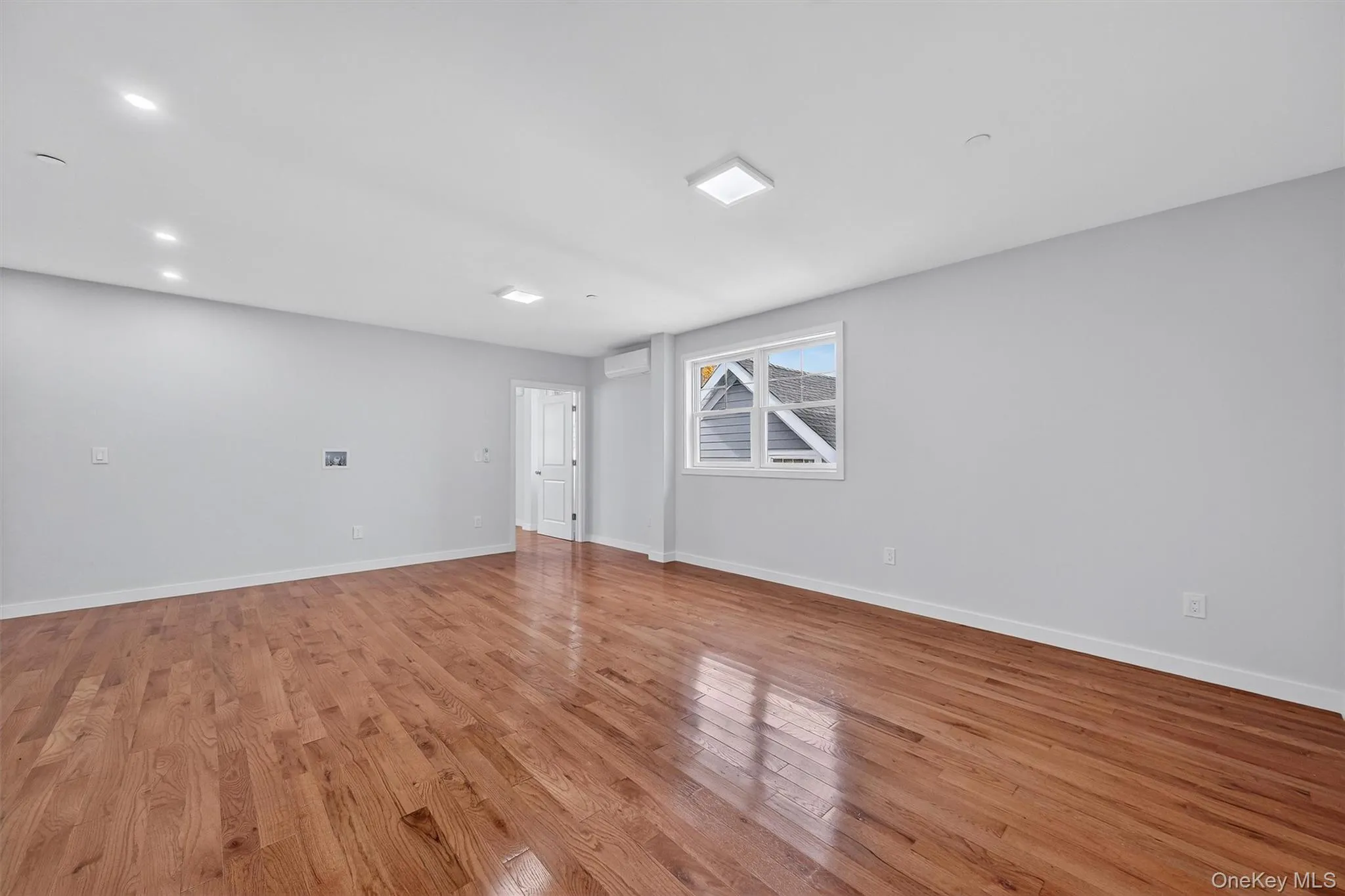 Unfurnished room with light wood finished floors and recessed lighting Unfurnished room with light wood finished floors and recessed lighting