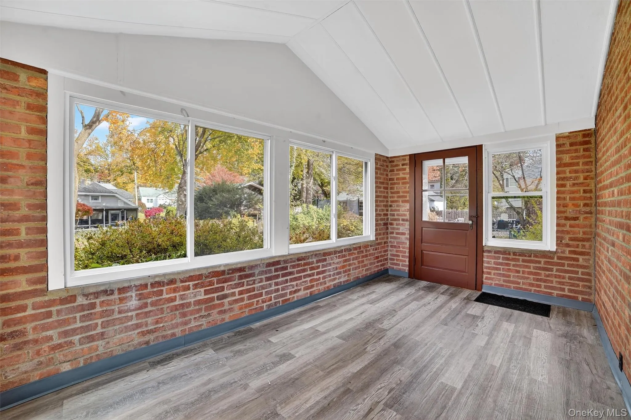 Unfurnished sunroom with lofted ceiling Unfurnished sunroom with lofted ceiling