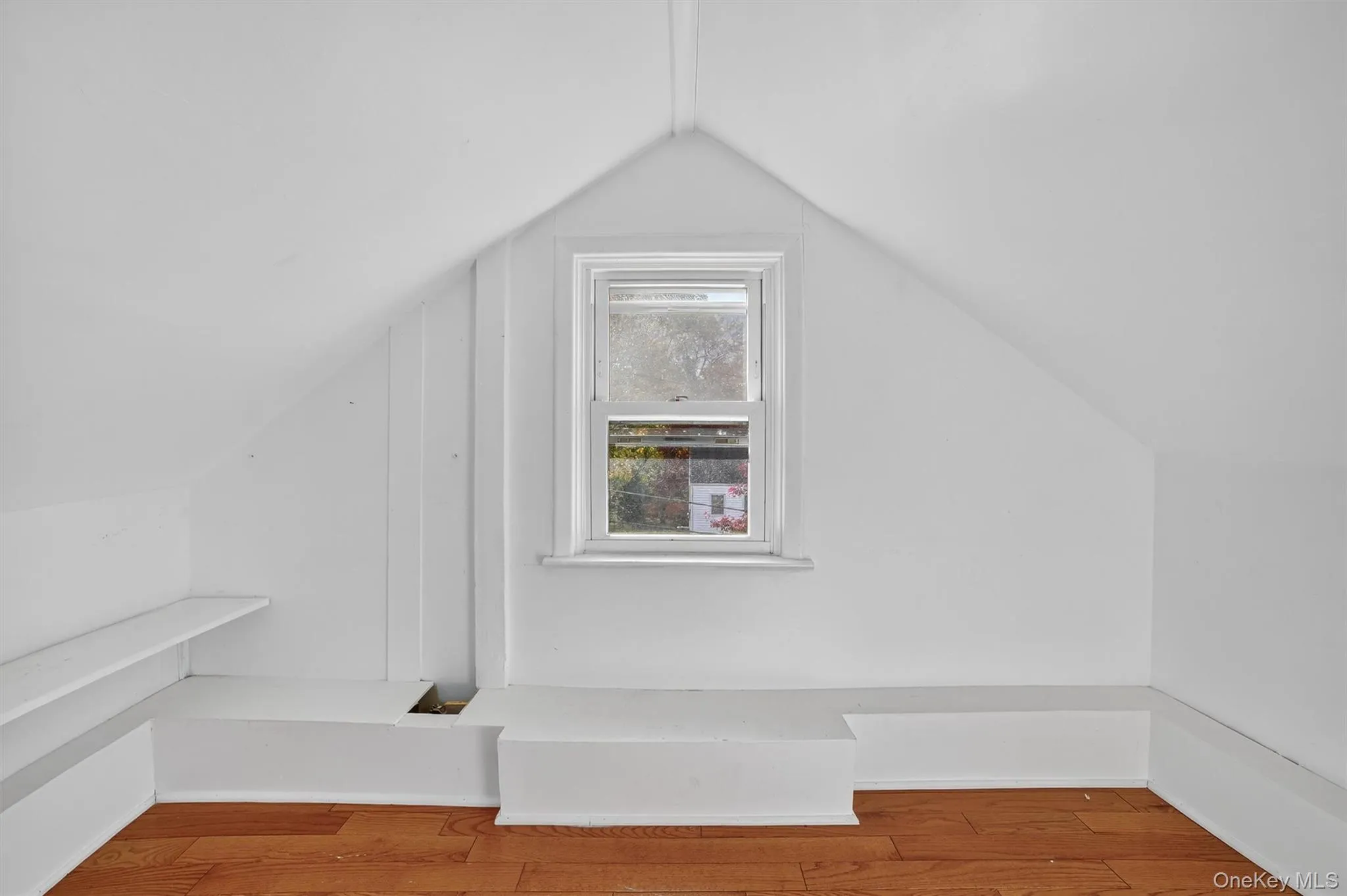 Additional living space featuring lofted ceiling and wood finished floors Additional living space featuring lofted ceiling and wood finished floors