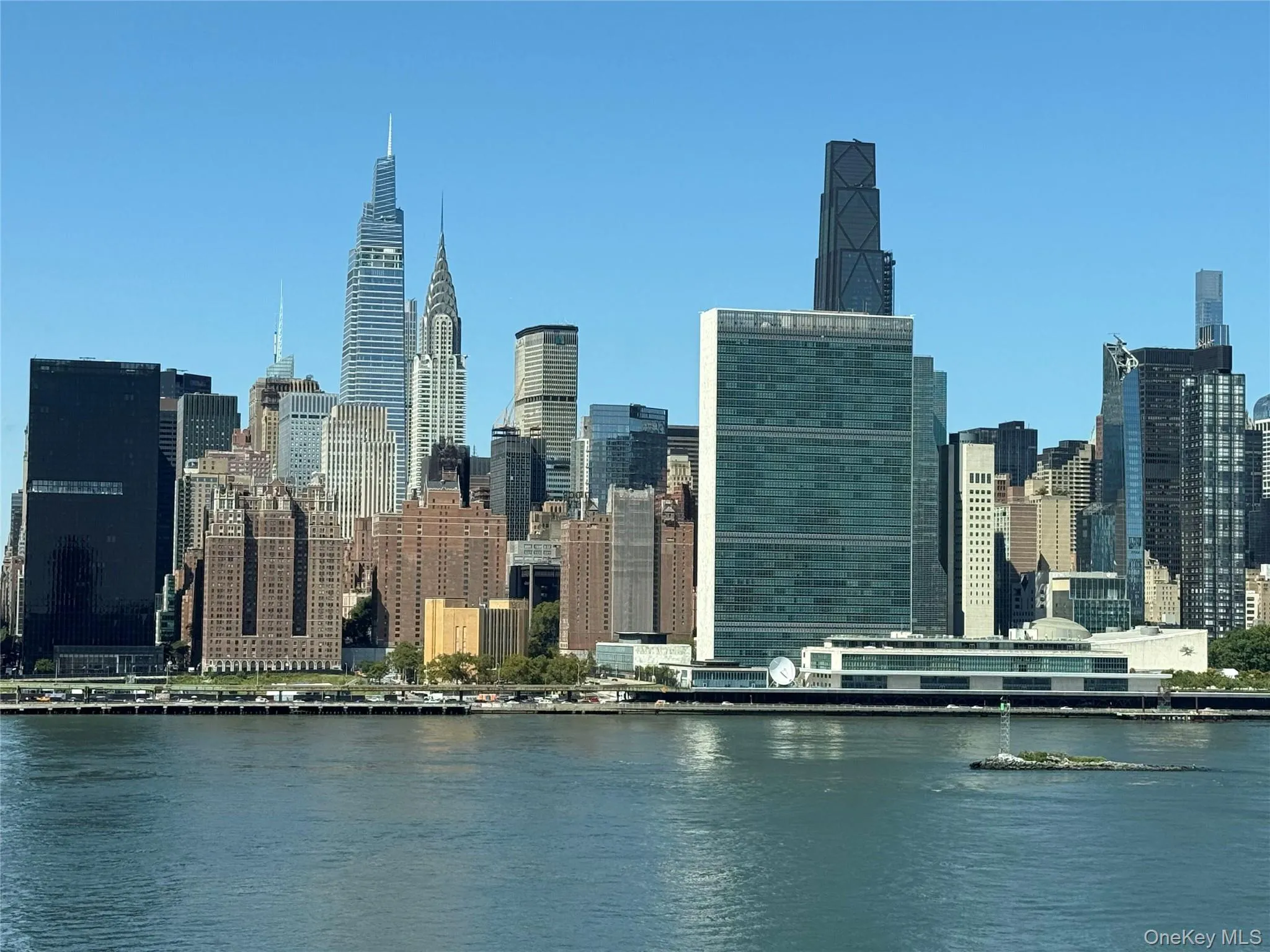 View of city skyline featuring a nearby body of water View of city skyline featuring a nearby body of water