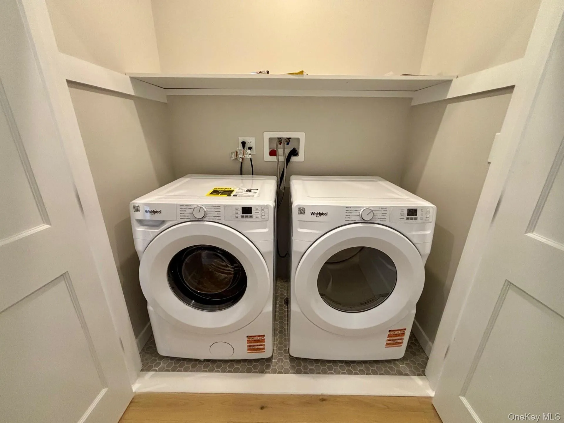 Laundry room featuring light wood-type flooring and washing machine and dryer Laundry room featuring light wood-type flooring and washing machine and dryer