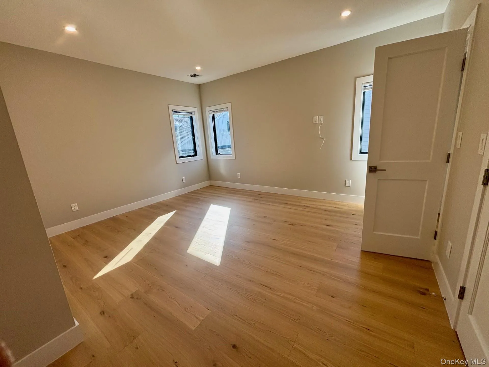 Empty room with recessed lighting and light wood-style flooring Empty room with recessed lighting and light wood-style flooring