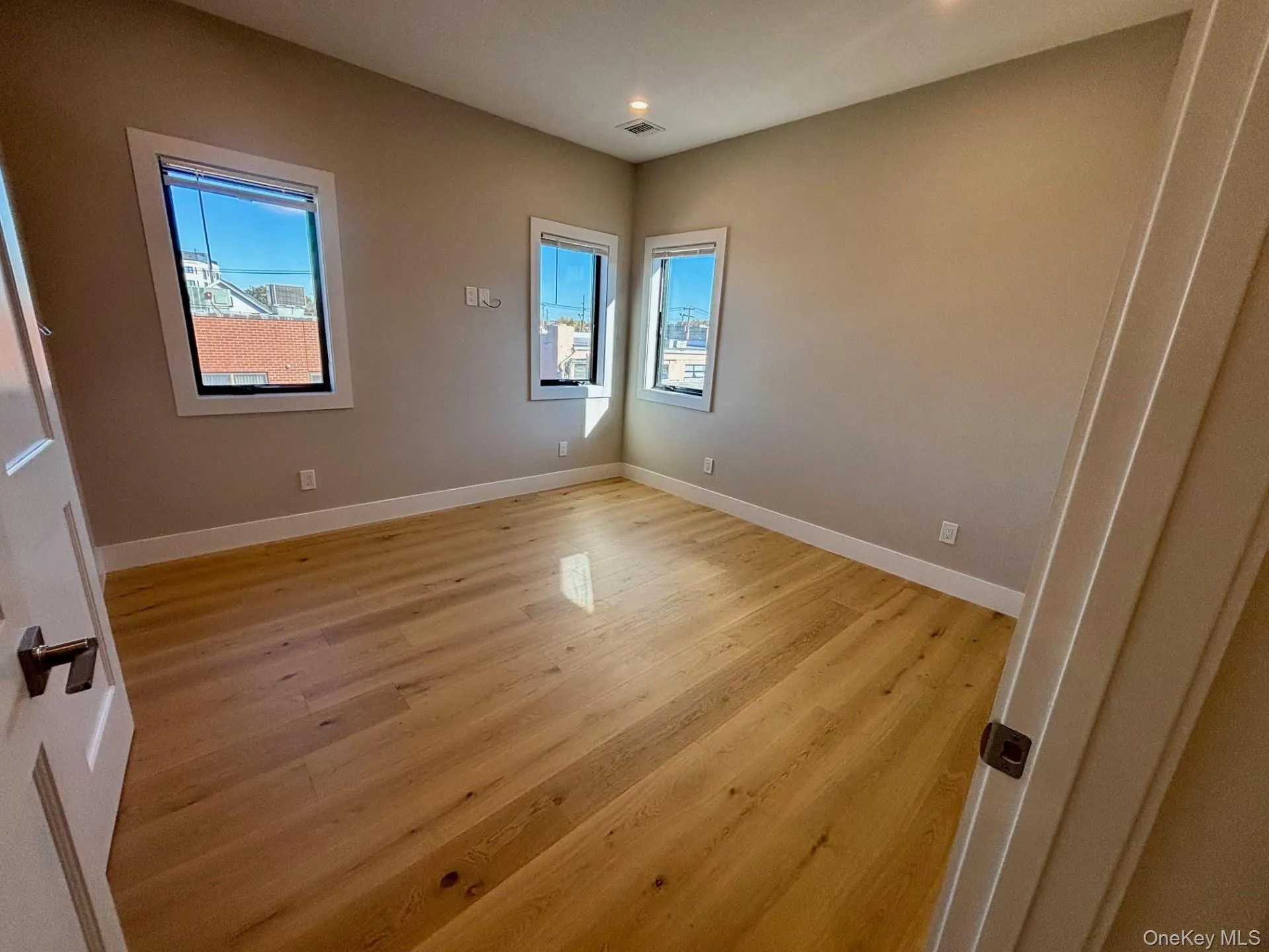 Empty room with light wood-type flooring and recessed lighting Empty room with light wood-type flooring and recessed lighting