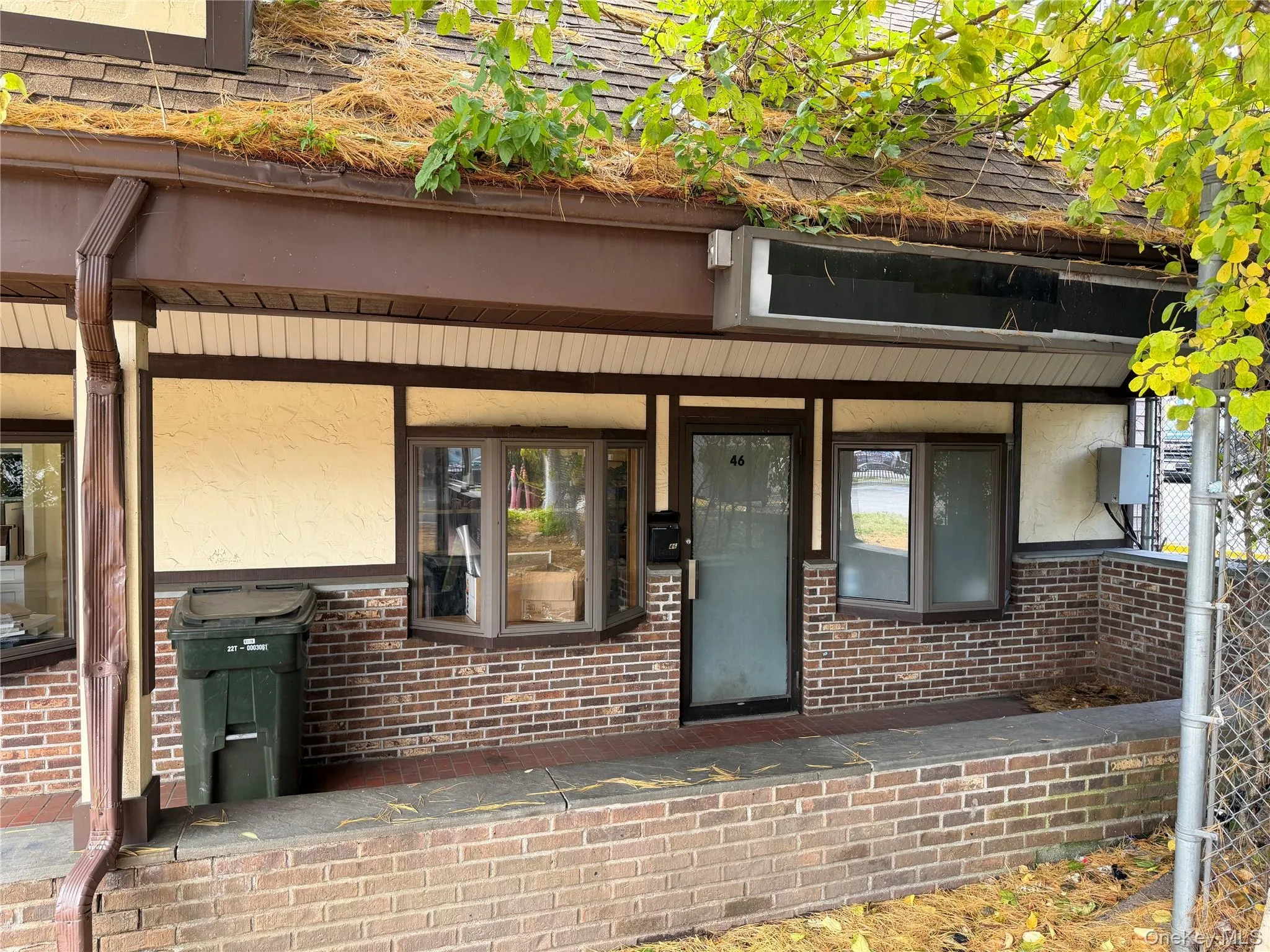 Doorway to property featuring a porch, brick siding, and stucco siding Doorway to property featuring a porch, brick siding, and stucco siding