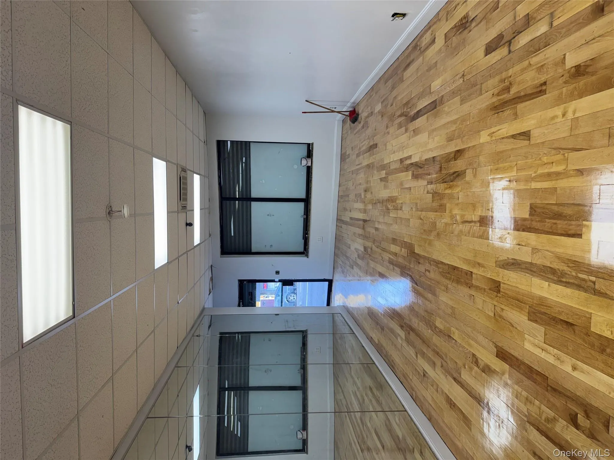 Spare room with light wood finished floors and a paneled ceiling Spare room with light wood finished floors and a paneled ceiling