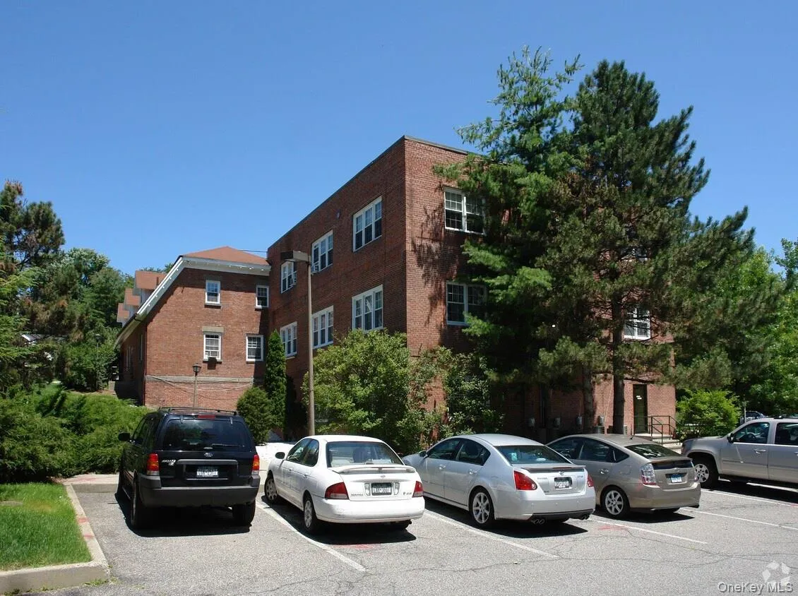 View of property featuring uncovered parking View of property featuring uncovered parking