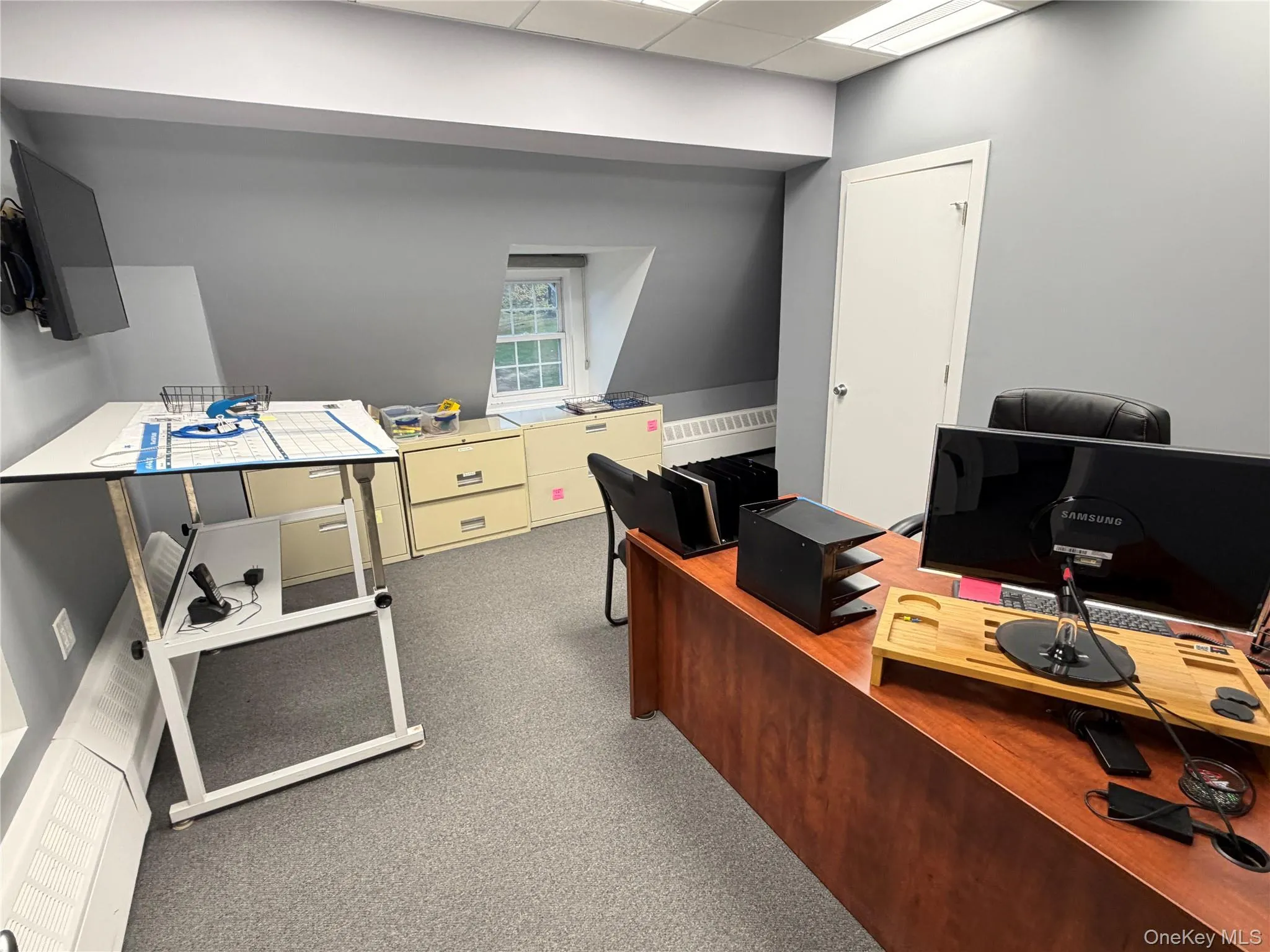 Carpeted home office with a paneled ceiling Carpeted home office with a paneled ceiling