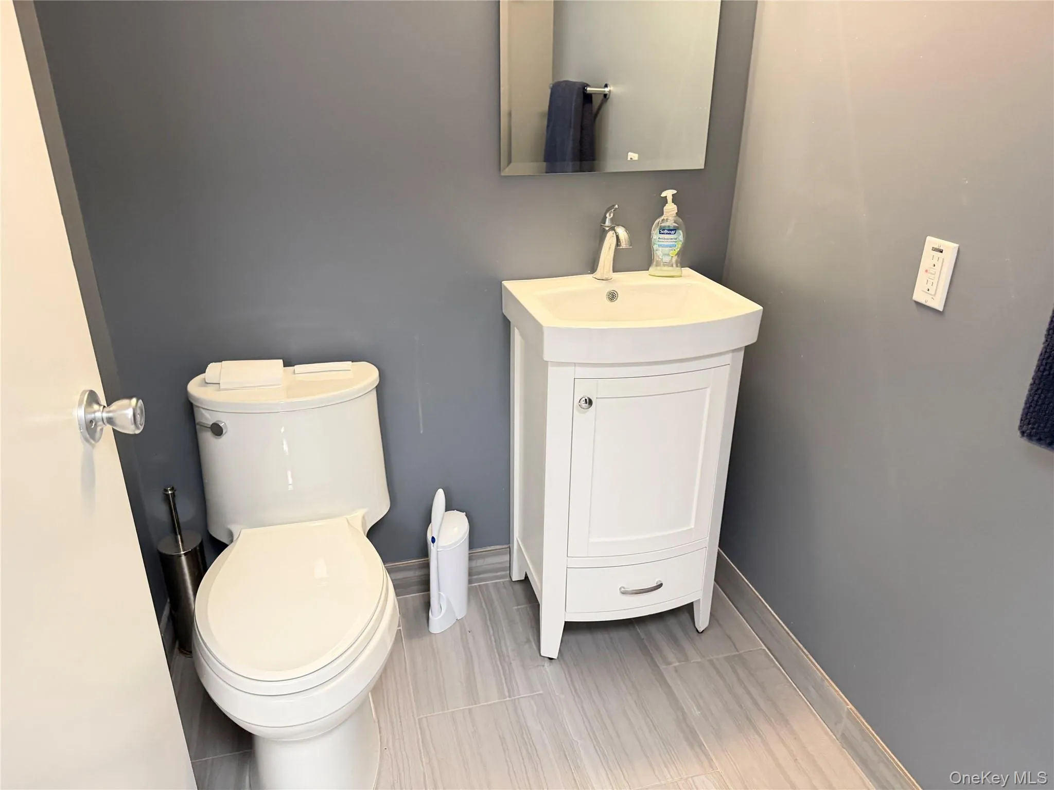 Half bathroom featuring baseboards and vanity Half bathroom featuring baseboards and vanity