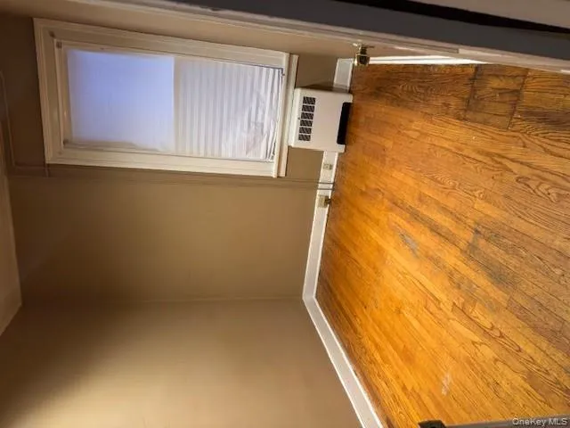Spare room with light wood-style floors and radiator heating unit Spare room with light wood-style floors and radiator heating unit