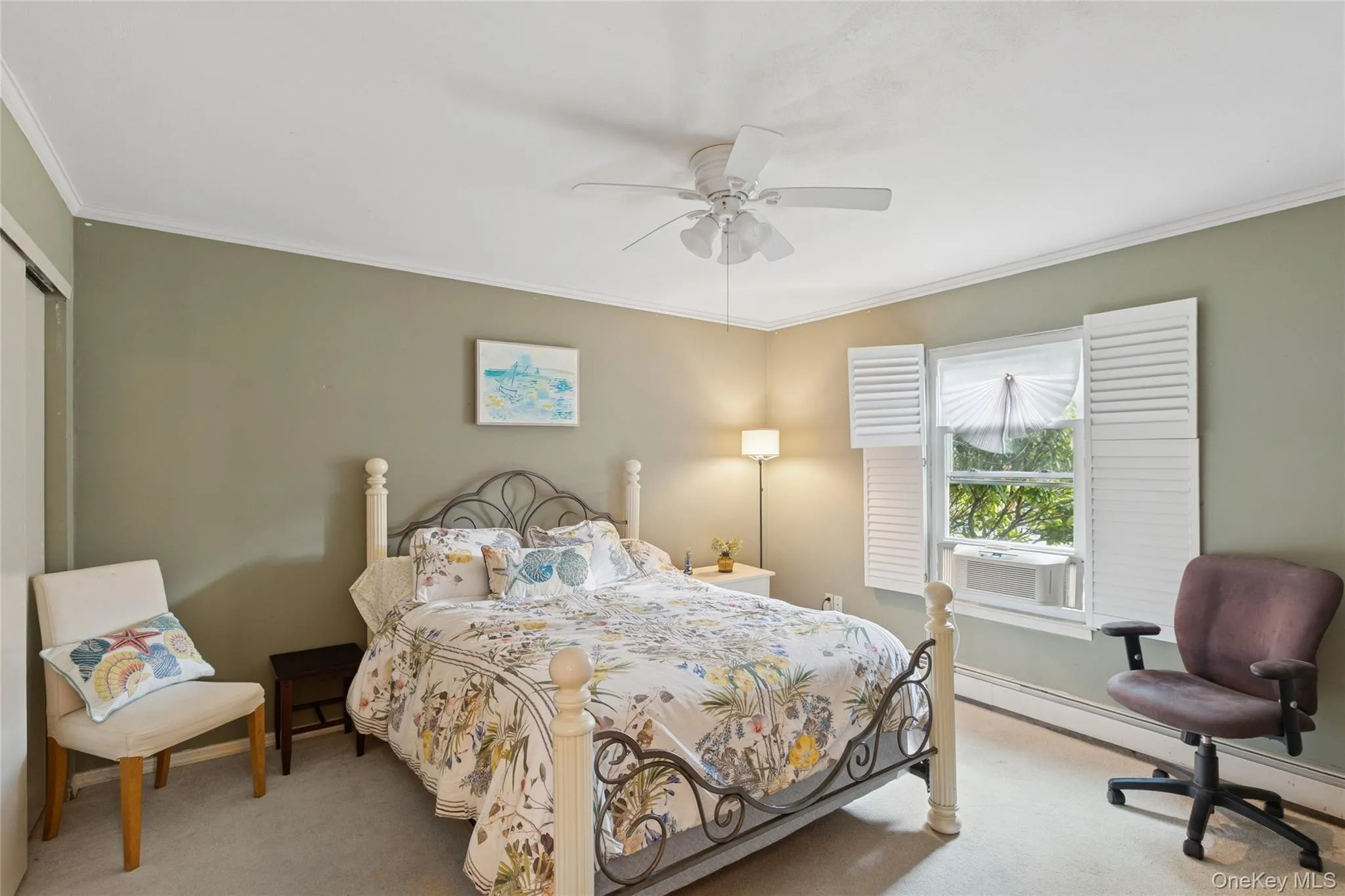 Bedroom featuring crown molding, carpet flooring, a baseboard radiator, a ceiling fan, and cooling unit Bedroom featuring crown molding, carpet flooring, a baseboard radiator, a ceiling fan, and cooling unit