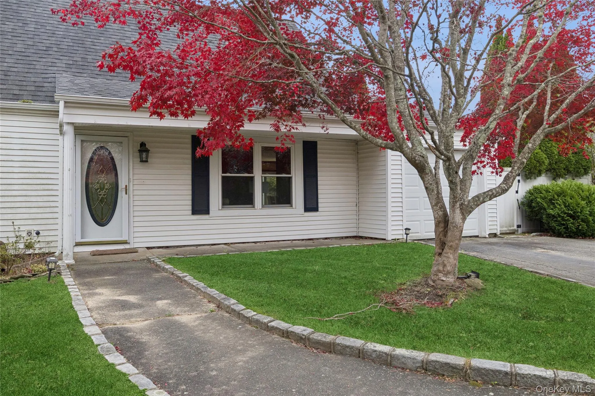 View of front of property featuring roof with shingles, a front yard, and driveway View of front of property featuring roof with shingles, a front yard, and driveway
