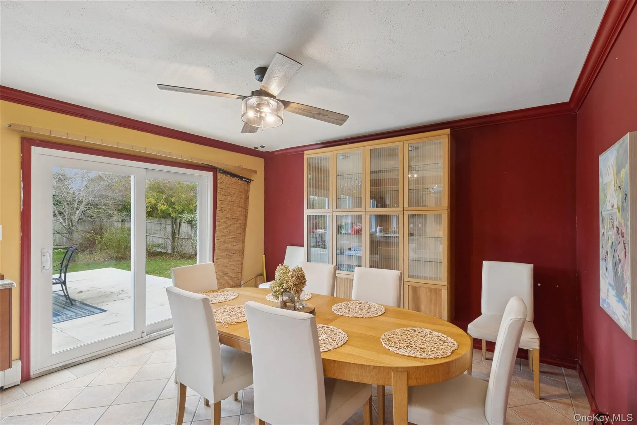 Dining space featuring light tile patterned floors, crown molding, and a ceiling fan Dining space featuring light tile patterned floors, crown molding, and a ceiling fan